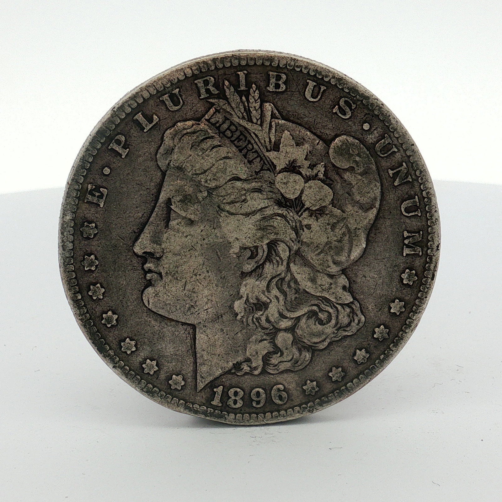 1896-O US Morgan Silver Dollar Coin Circulated: This 1896 US Morgan silver dollar was struck at the New Orleans mint. The coin is composed of 90 percent silver and 10 percent copper. The obverse features the Morgan Liberty head design encircled by 