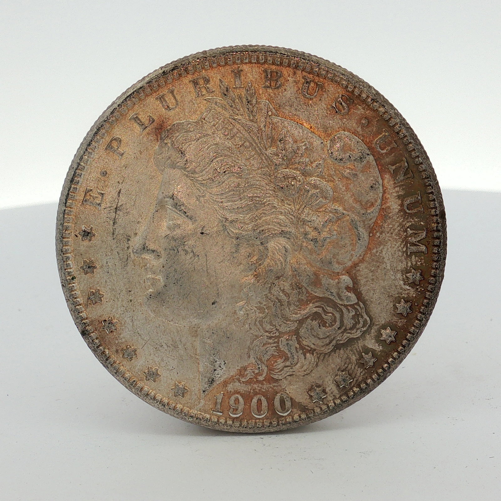 1900-O US Morgan Silver Dollar Coin Circulated: This US Morgan dollar is dated 1900 and was struck at the New Orleans Mint. The coin is composed of 90 percent silver and 10 percent copper. The obverse features the Liberty Head design, and the rever