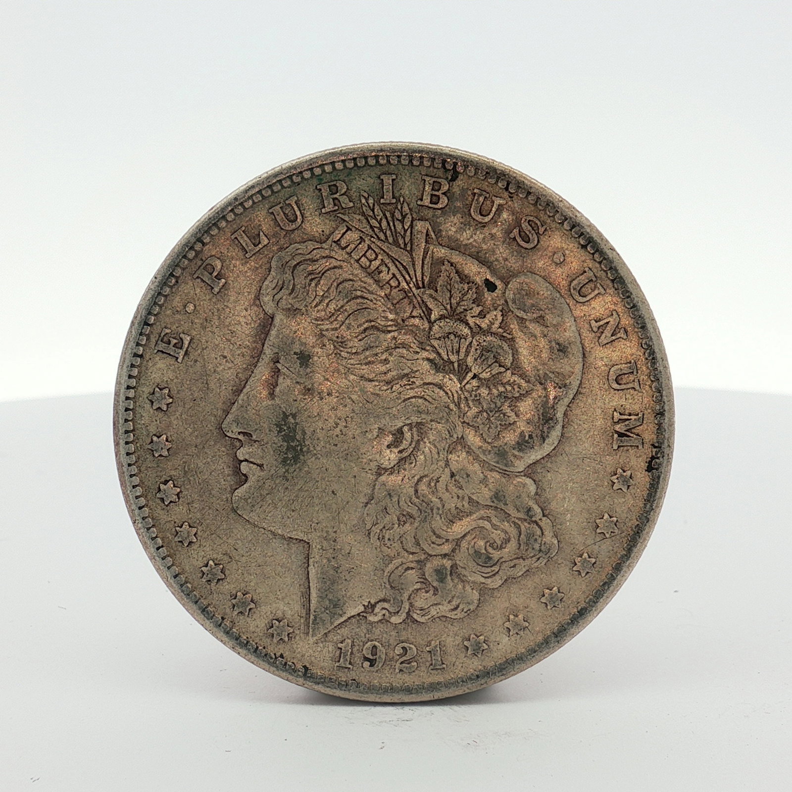 1921-S US Morgan Silver Dollar Coin Circulated: This US 1921-S Morgan silver dollar was struck at the San Francisco Mint. The coin is composed of 90% silver. It features the Morgan dollar design type. The S mint mark is located on the reverse above