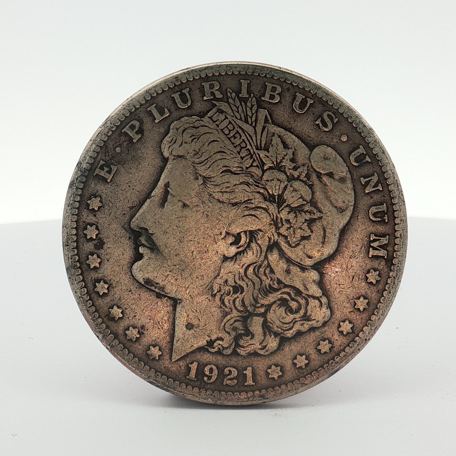 1921-S US Morgan Silver Dollar Coin Circulated: This US silver coin is a 1921-S Morgan dollar. It features the Liberty Head obverse and the Eagle reverse. The San Francisco S mint mark is located on the reverse centrally above the DOLLAR inscriptio