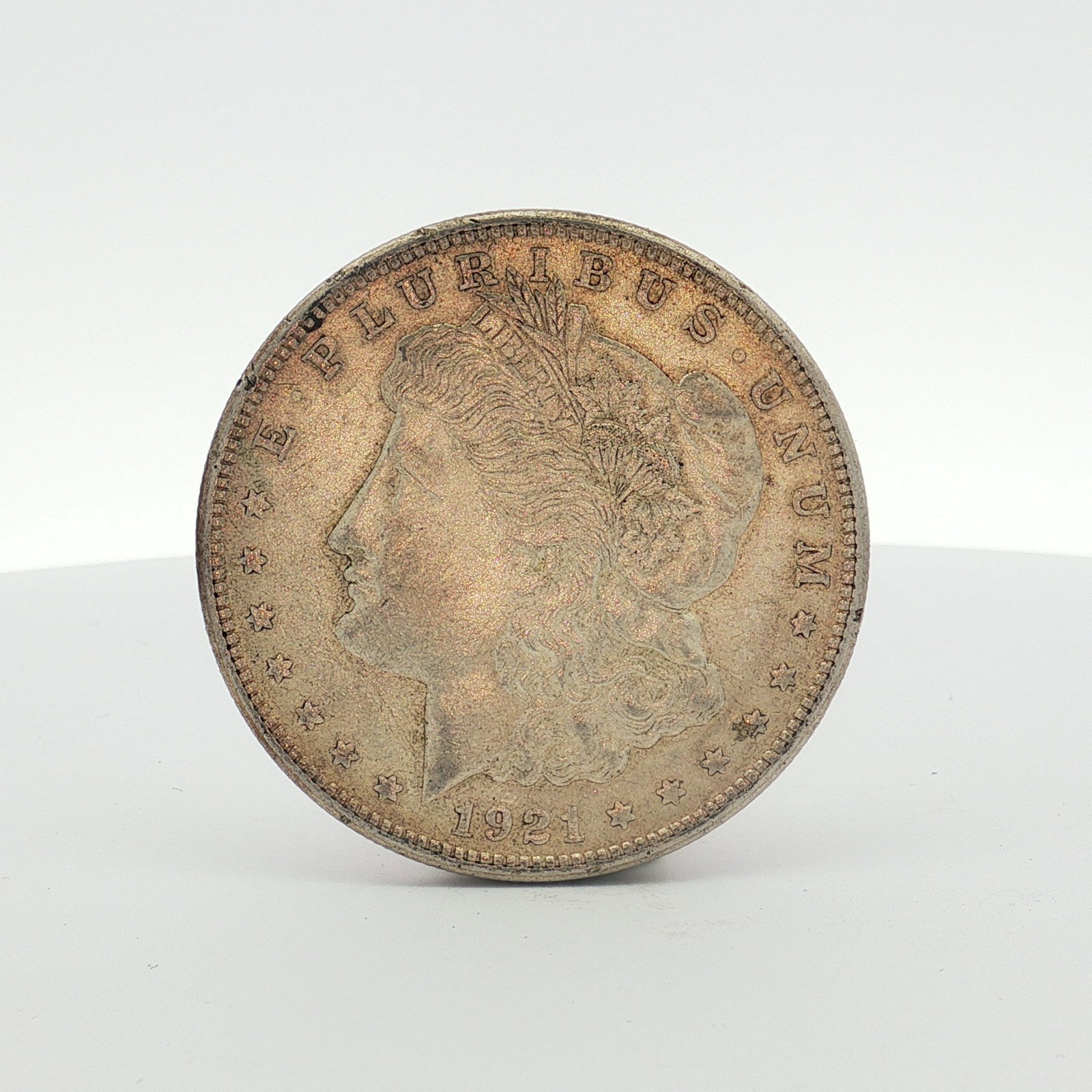 1921-S US Morgan Silver Dollar Coin Circulated: This coin is struck in 90 percent silver and 10 percent copper. The obverse features the Morgan dollar design with the date 1921 and the legend E PLURIBUS UNUM. The reverse features the heraldic eagle