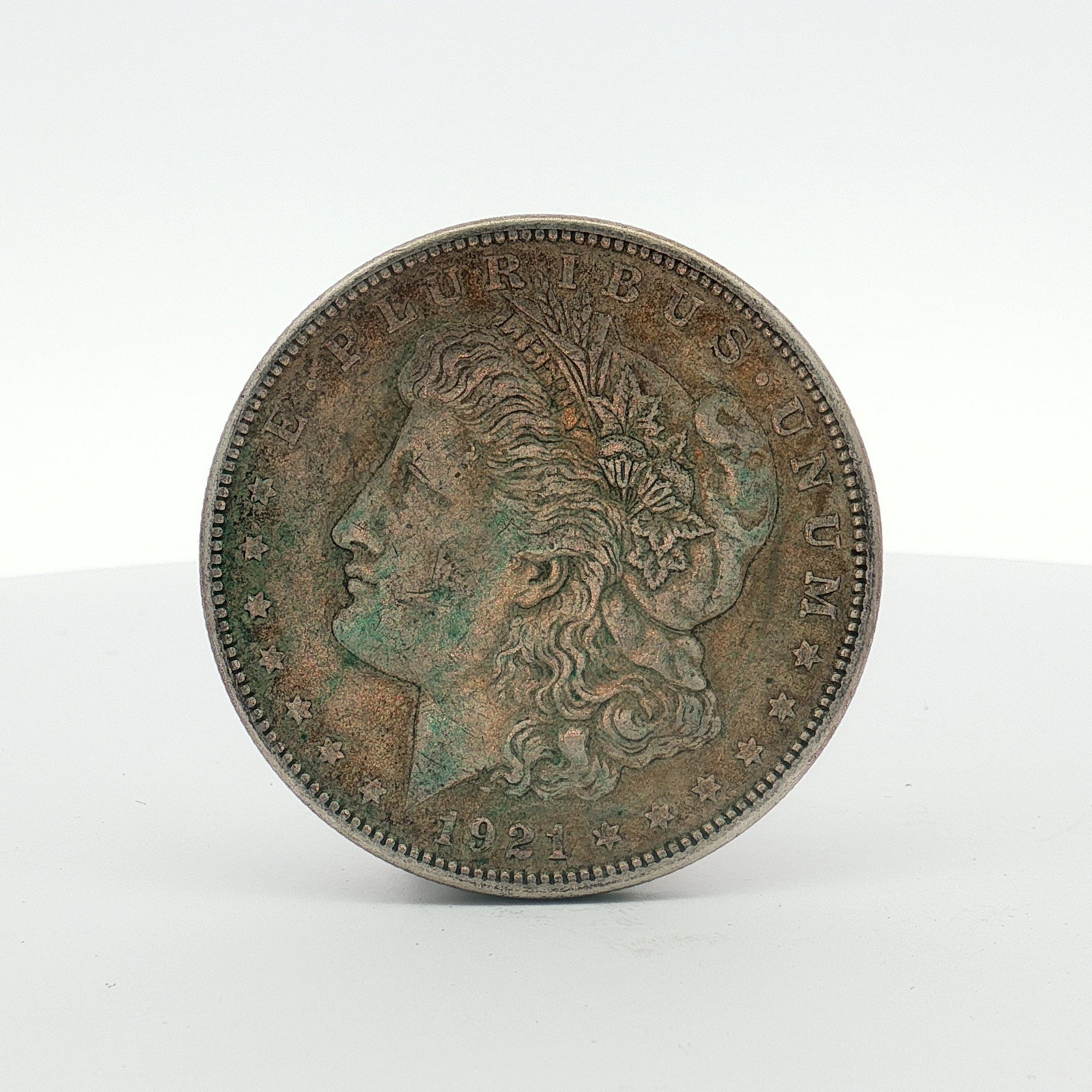 1921-S US Morgan Silver Dollar Coin Circulated: This US 1921-S Morgan silver dollar is a 90% silver coin struck at the San Francisco Mint. The piece features the George T. Morgan design. The S mint mark is located on the reverse, centered below the