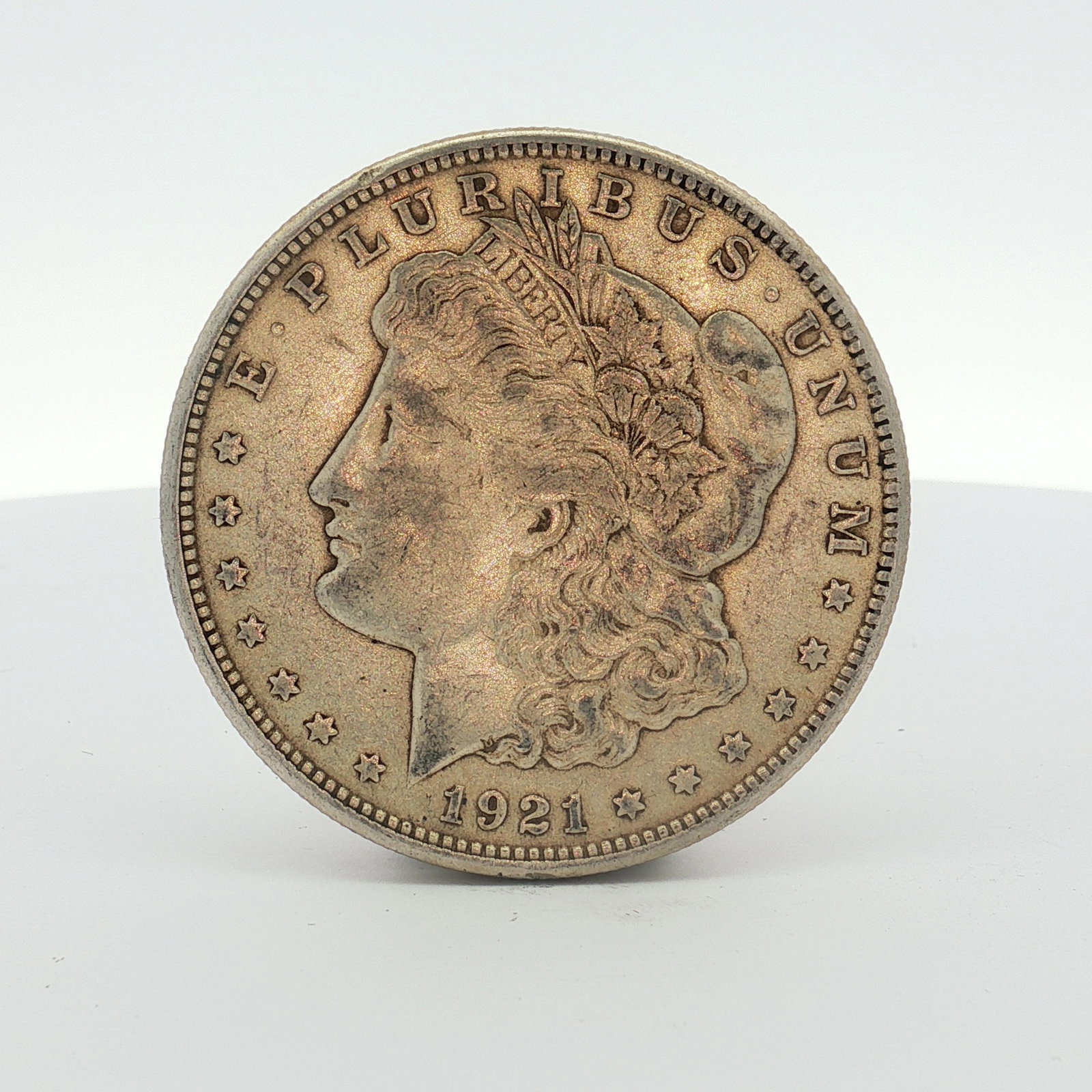 1921-S US Morgan Silver Dollar Coin Circulated: This US Morgan silver dollar was struck at the San Francisco Mint in 1921. The coin is composed of 90% silver and 10% copper with a fineness of .900. The obverse features the Morgan dollar design with
