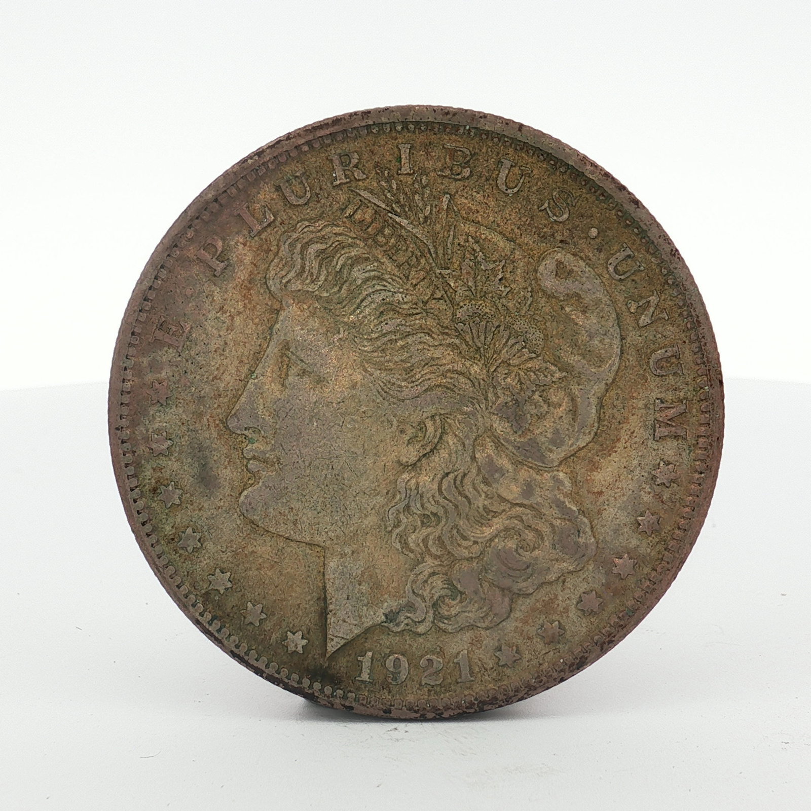 1921-S US Morgan Silver Dollar Coin Circulated: US 1921-S Morgan silver dollar. This coin is struck in silver. It was minted at the San Francisco Mint, as indicated by the S mint mark on the reverse above the letters DO in DOLLAR. The obverse featu