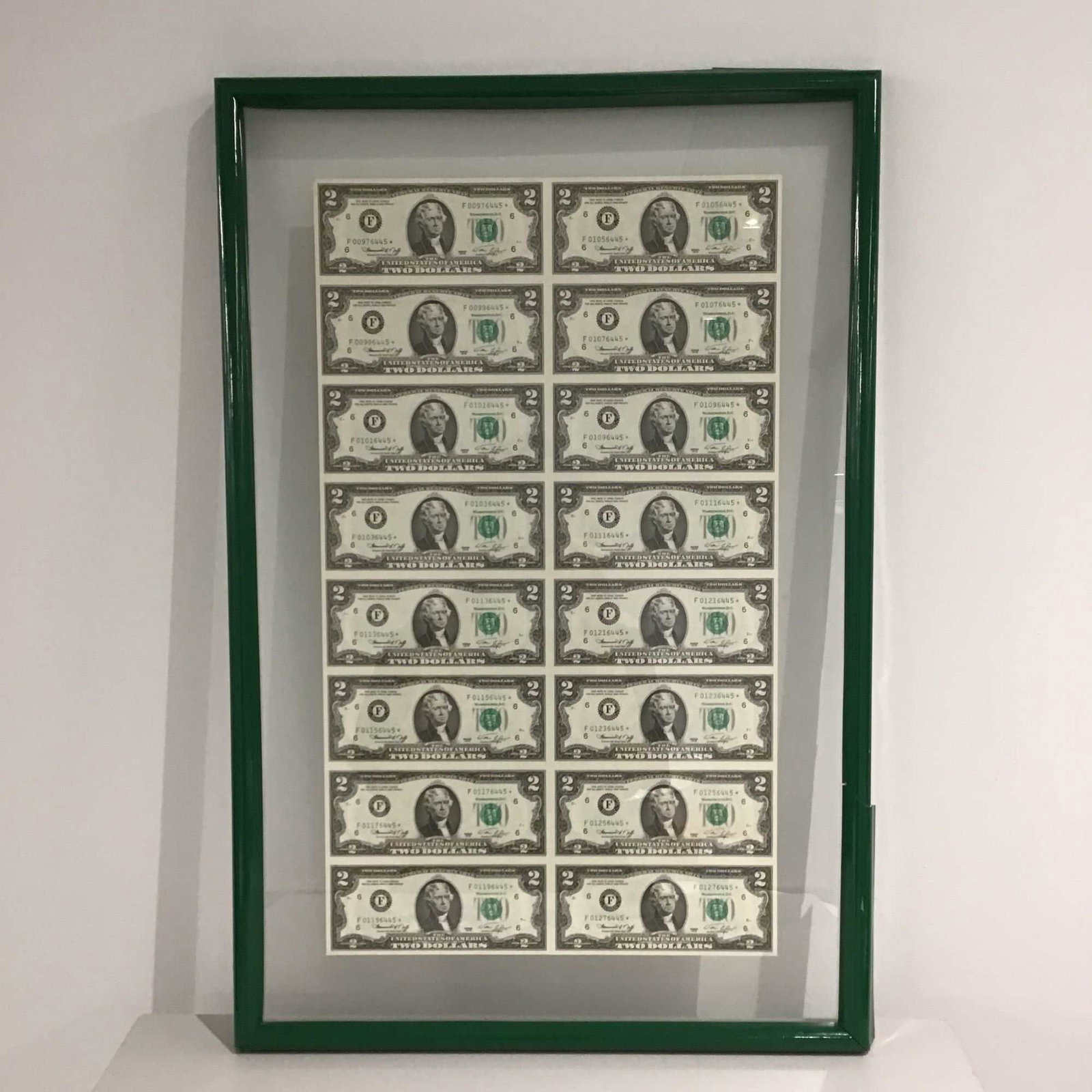 1976 $2 Bills Framed Uncut Sheet: This framed, uncut sheet features sixteen Series 1976 $2 Federal Reserve Notes. These bills showcase the portrait of Thomas Jefferson on the front and a detailed engraving of the signing of the Declar