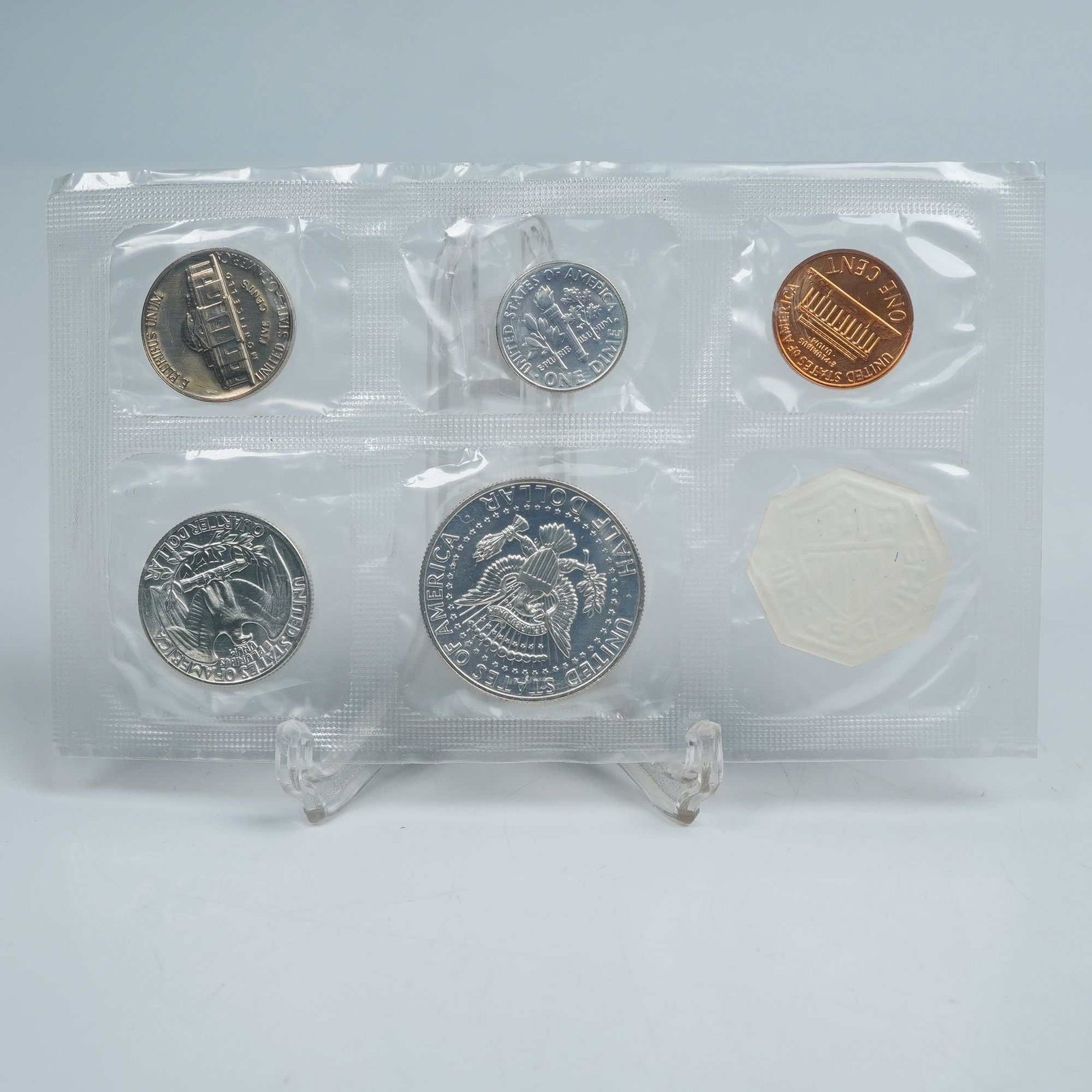 1964 U.S. Mint Philadelphia Proof Set of 6 Coins with Token: A complete 1964 Philadelphia Mint Proof Set featuring six coins sealed in Original Government Packaging (OGP). The set includes the Lincoln Cent, Jefferson Nickel, Roosevelt Dime, Washington Quarter, 