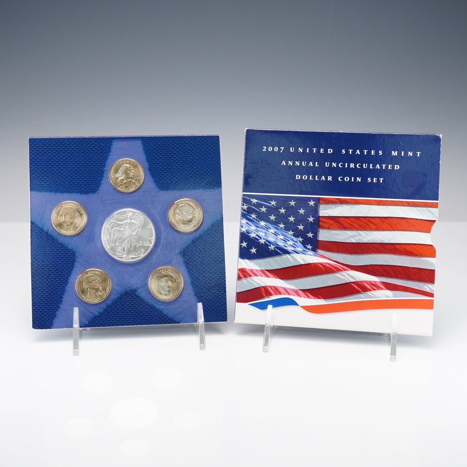 2007 United States Mint Annual Uncirculated Dollar Coin Set: A complete 2007 U.S. Mint Annual Uncirculated Dollar Coin Set presented in original mint packaging. The set includes six coins: one 2007-W Burnished American Silver Eagle containing 1 oz of .999 fine 