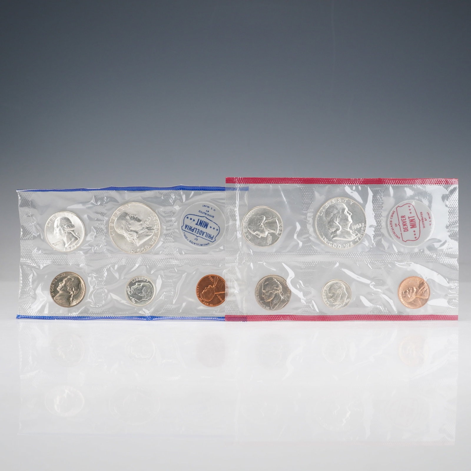 2pc 1962 United States Mint Proof Coin Sets: This 1962 United States Mint Uncirculated Coin Set features two complete assortments of coins, one struck at the Philadelphia Mint and the other at the Denver Mint. Each set includes the Lincoln cent,