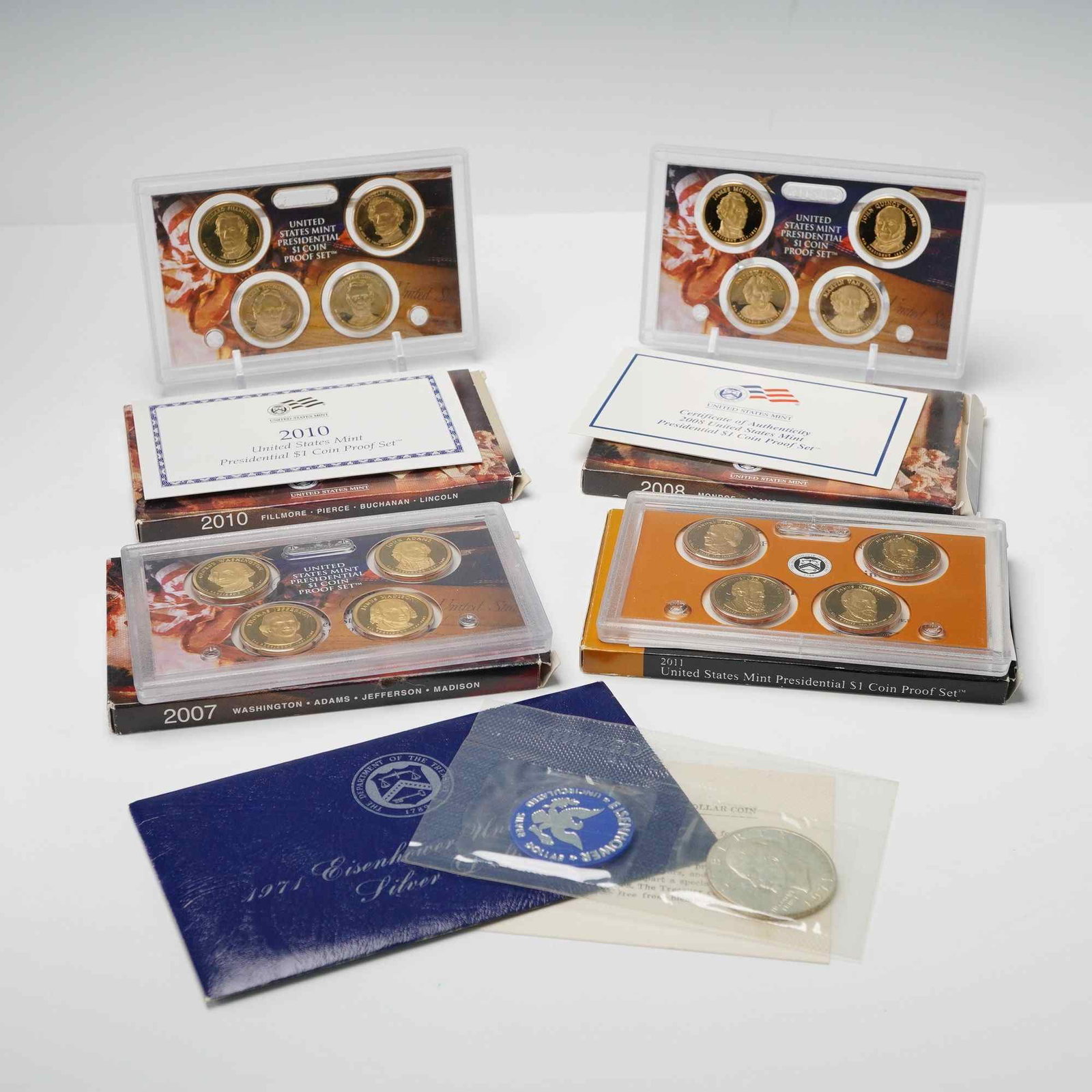5pc 1971, 2007, 2008, 2010 & 2011 U.S. Presidential $1 Coin Proof Set: Proof Sets representing multiple years of the modern Presidential Dollar Program and one earlier silver issue. 1971 Eisenhower Silver Dollar " Original U.S. Mint blue envelope with encapsulated 40% si