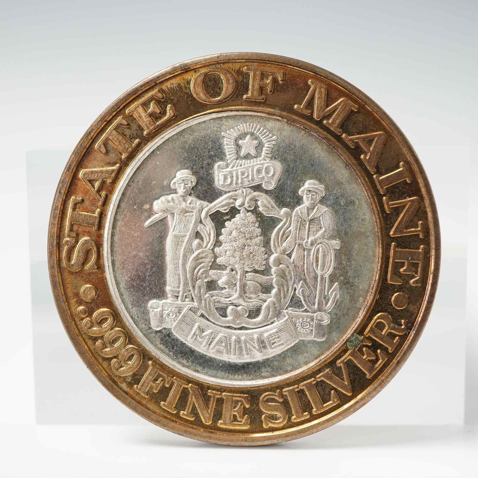 1994 Foxwoods Resort Casino State of Maine $10 Gaming Token: Limited-edition Foxwoods Resort Casino ten-dollar gaming token issued in 1994, featuring a brass outer ring encircling fine silver center. The obverse shows the Foxwoods signature design with a fox st