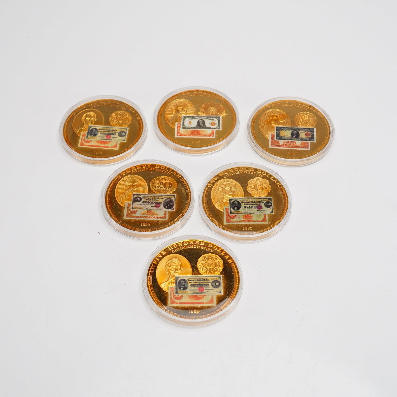 Collection of 1882, 1905, 19047 & 1922 US Gold Certificate Commemorative Medals in Original Box: A collection of American Mint commemorative medals honoring historical US Gold Certificates. These metal gold certificate coins feature a proof finish with mirrored fields and frosted relief. The obve
