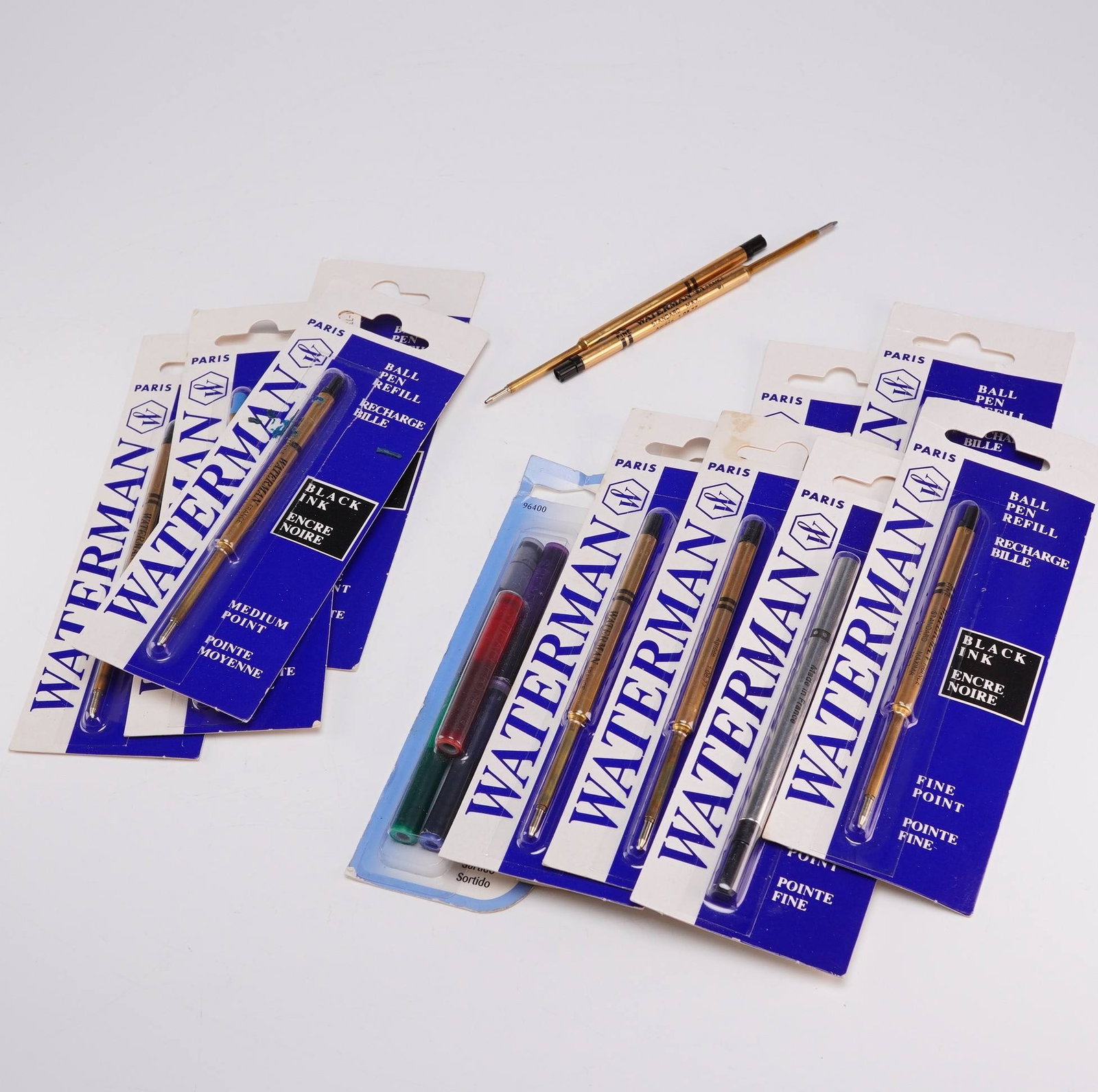 14pc Waterman and Sheaffer Pen Refills and Ink Cartridges: This collection consists of fourteen pen refills and ink cartridges. The assortment includes several Waterman ballpoint pen refills in original retail blister packs, categorized as medium point and fi