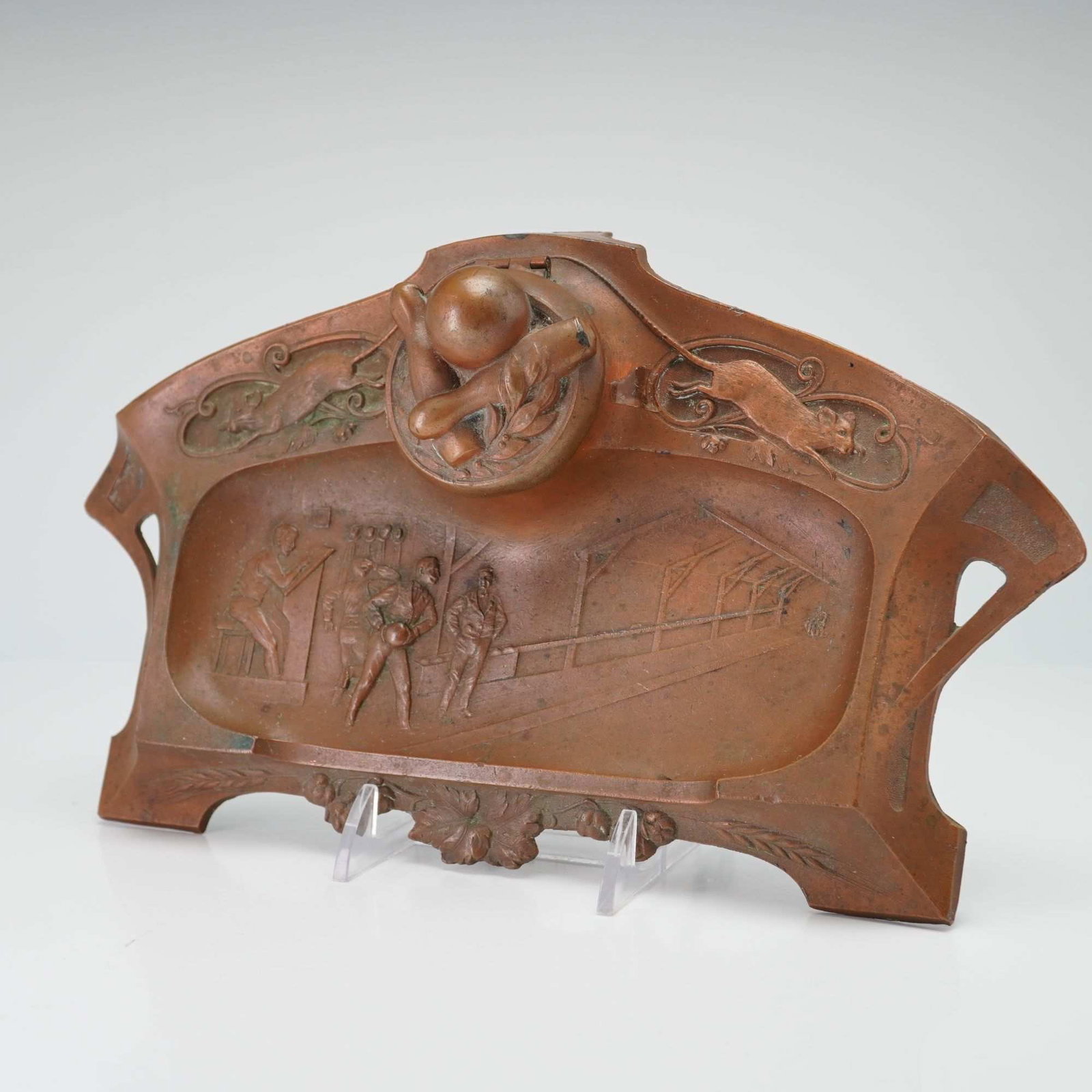 Art Nouveau Copper Metal Bowling Theme Inkwell: This Art Nouveau era inkwell is composed of copper metal and features a bowling theme. The design is consistent with German metalware of the period. The central hinged lid is modeled as a bowling ball