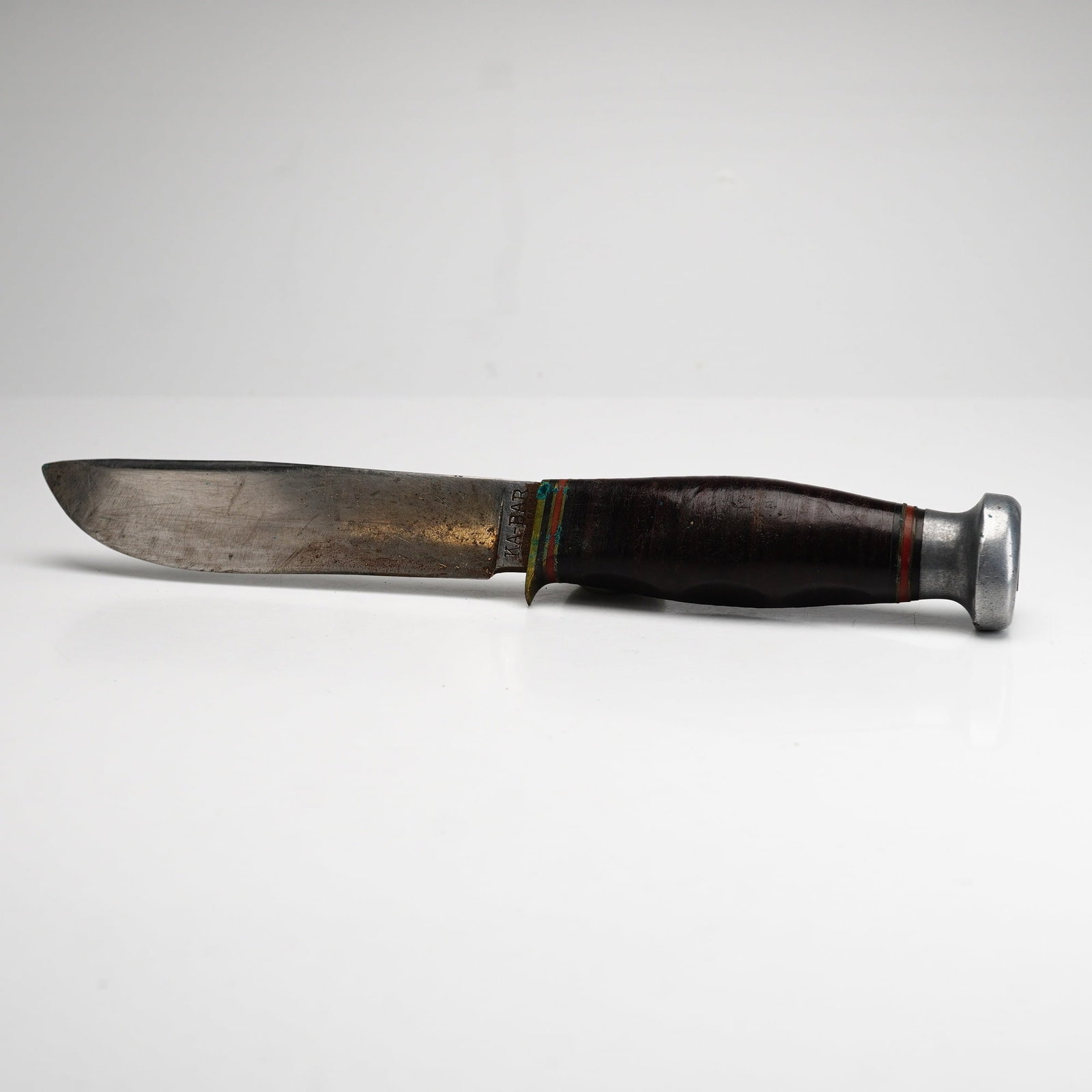 Vintage KA-BAR Official Boy Scout Fixed Blade Hunting Knife with Leather Sheath: This vintage fixed-blade hunting knife is an official Boy Scout model produced by KA-BAR (Union Cutlery Co., Olean, NY). The knife features a carbon steel drop point blade and a contoured handle const