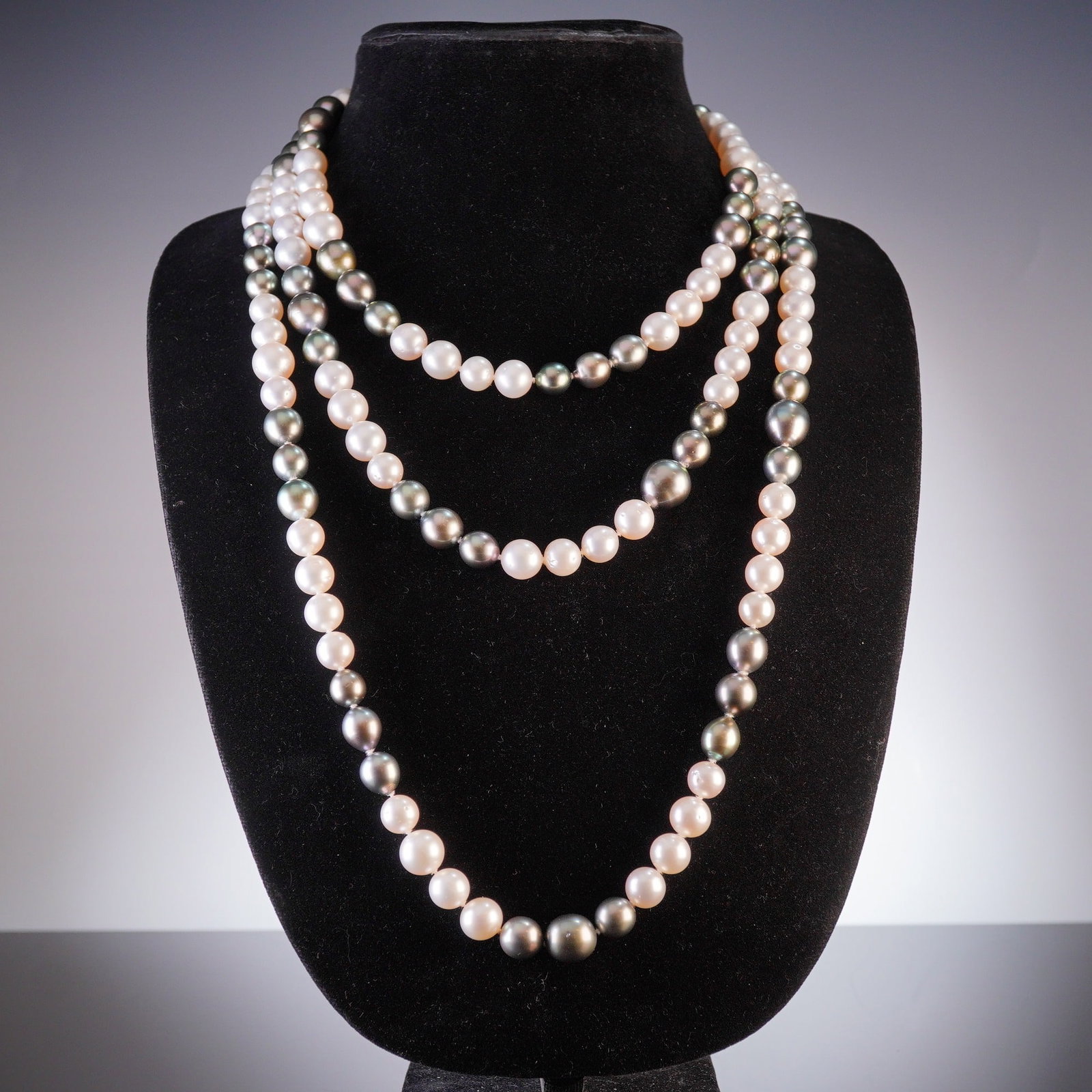 White South Sea and Tahitian Ombre Pearl Necklace: An estate necklace featuring a combination of white South Sea and Tahitian cultured pearls. The long strand is designed with a color gradient transitioning from creamy white pearls with pinkish overto
