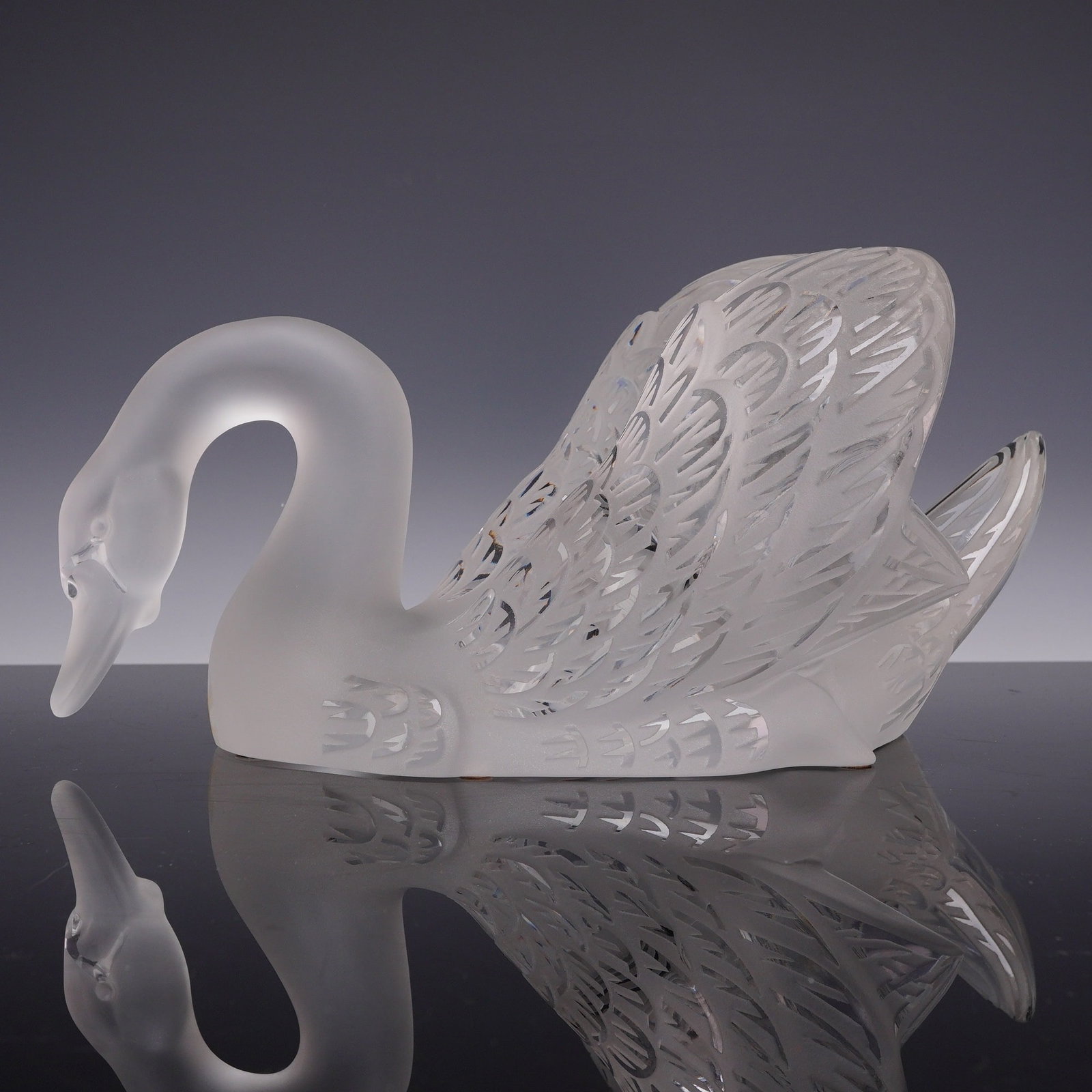 Lalique France Large Frosted and Clear Crystal Swan Head Down Sculpture: Large Lalique France lead crystal figurine depicting a swan in a graceful head down swimming pose, known as Cygne, T?te Penchee. Originally designed by Rene Lalique in 1943, this piece features a fros