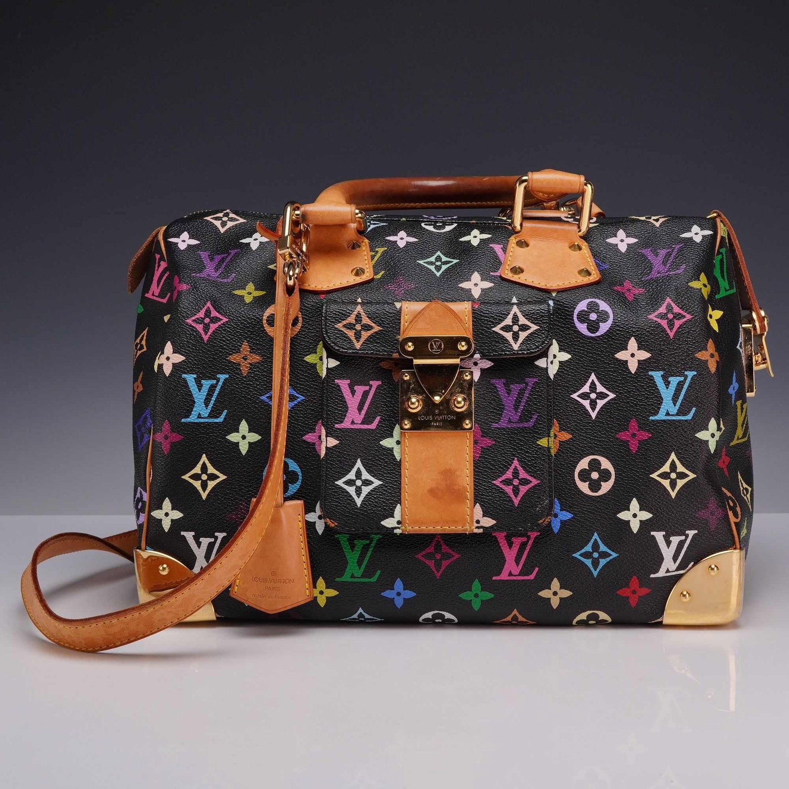 Louis Vuitton x Takashi Murakami Black Monogram Multicolore Speedy 30 Bag: This Louis Vuitton Speedy 30 is from the Monogram Multicolore collection, a collaboration between the fashion house and Japanese artist Takashi Murakami. The bag is crafted from black coated canvas fe