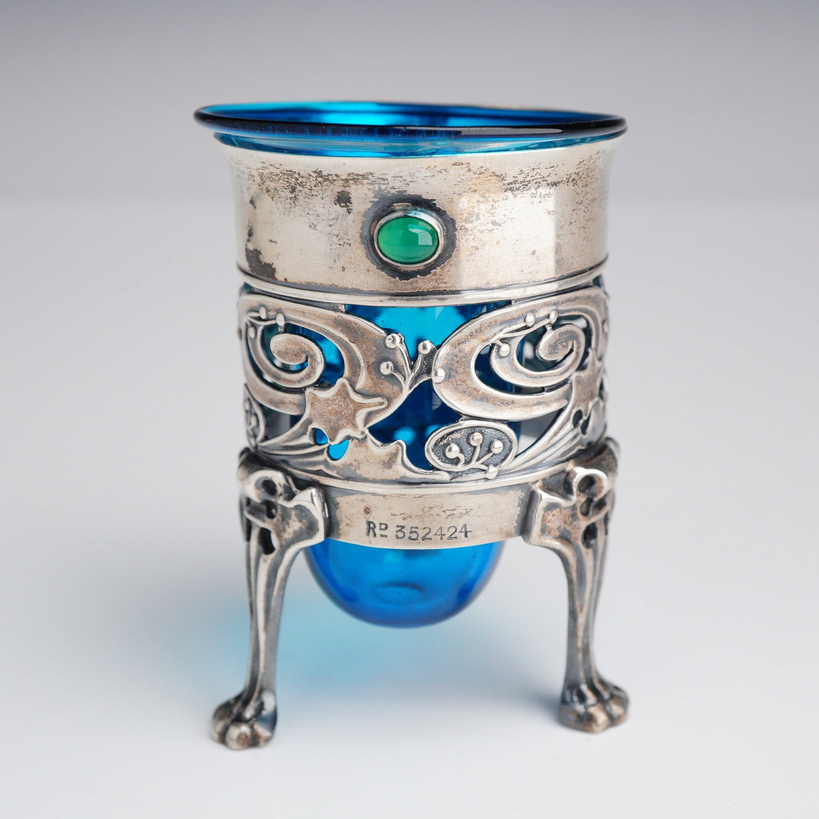 Art Nouveau Sterling Silver and Cobalt Glass Pot Designed by Kate Harris for William Hutton and Sons: This London silver design features a pierced sterling silver mount with an intricate openwork pattern of stylized floral motifs and whiplash scrolls. The vessel is elevated on three out-swept legs ter