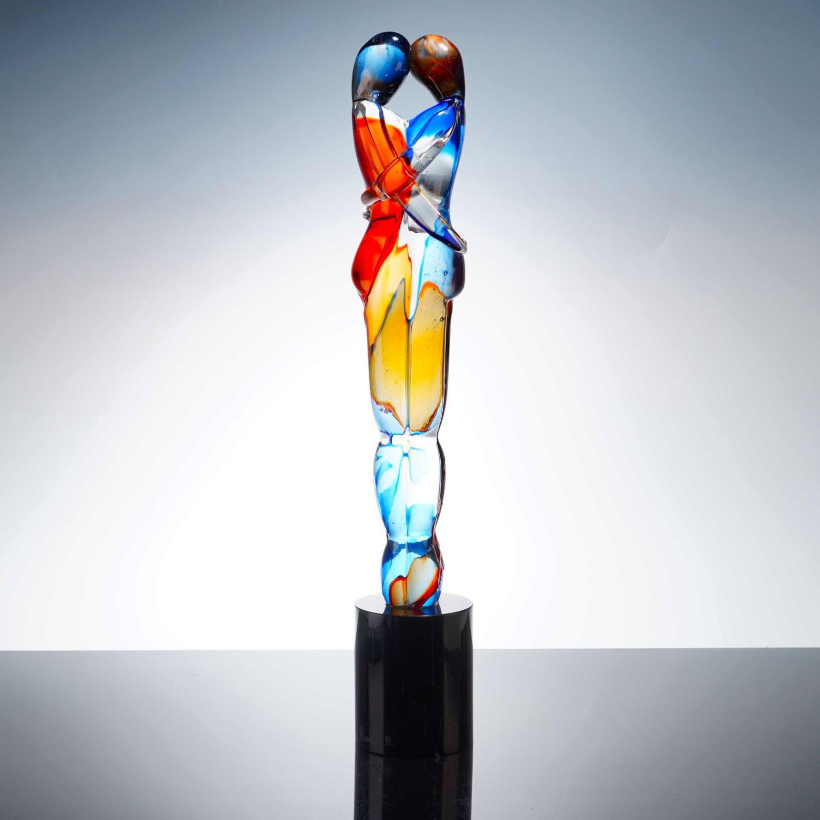 Mario Badioli for Oggetti Murano Art Glass Sculpture, Lovers Embrace: This contemporary art glass sculpture, identified as the Lovers Embrace model by Mario Badioli for Oggetti Murano, features two stylized, elongated figures in an intimate embrace. The work is construc
