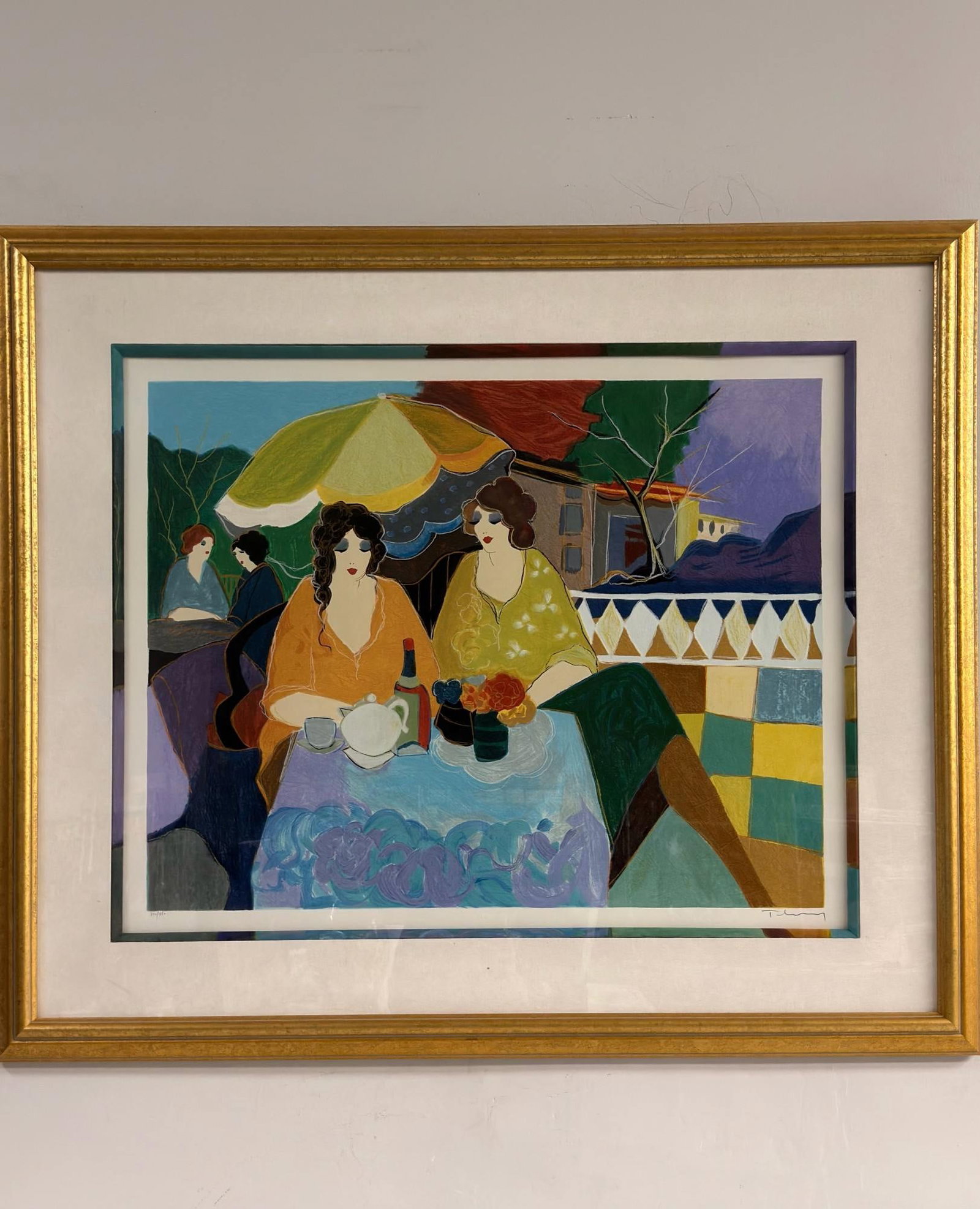 Itzchak Tarkay (Israeli, 1935-2012) Serigraph on Paper, Tea Garden, Signed & Numbered: The composition by Itzchak Tarkay depicts a group of women at an outdoor cafe, featuring two central female figures seated at a table set with a white teapot, a cup and saucer, a wine bottle, and a va