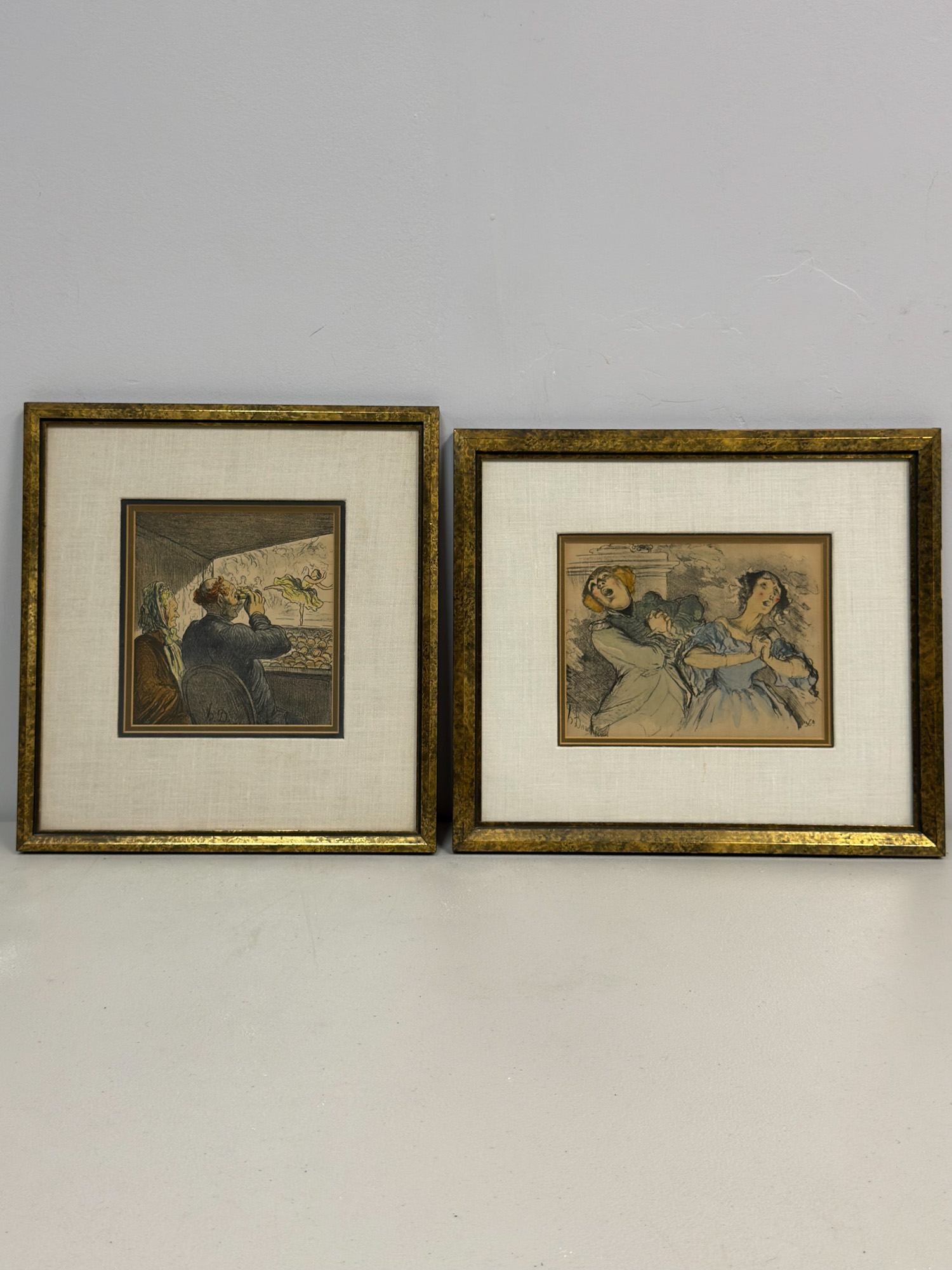 Honore Daumier (French, 1808-1879), Pair of Hand-Colored Lithographs on Paper: This pair of framed prints features theatrical subjects in the artist's signature satirical style. The first print, titled Fesant les delices du public de Carpentras, depicts a theater interior with a