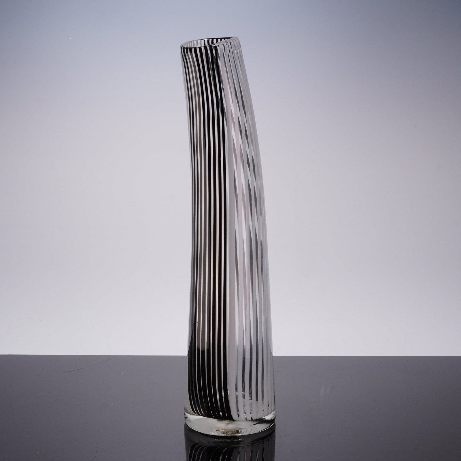 Attributed to Dino Martens Murano Style Bianco Nero Glass Vase: This hand-blown art glass vase is executed in the Bianca Nero style mezza filigrana, in the manner of Dino Martens for Aureliano Toso. The vessel features a tall, slender, and slightly canted cylindri