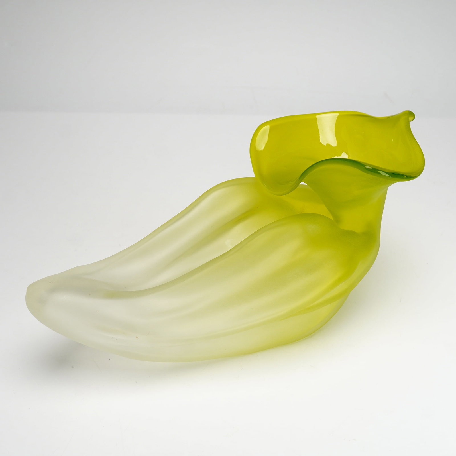 Nikolas Weinstein (American, b.1968) Art Glass Blossom Form Vase, 1998: The piece is designed in the shape of a blossom, featuring an organic, fluted form. The body is executed in a vibrant chartreuse or citron yellow glass that transitions to a translucent, pale frosted 