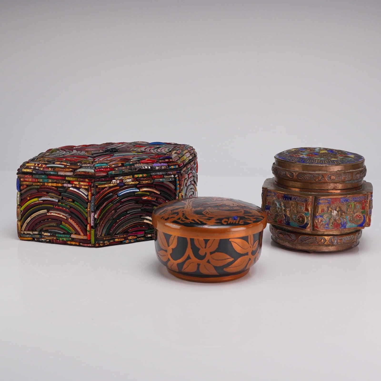 3pc Decorated Enameled, Boho Beaded & Lacquered Boxes: This three piece decorated box grouping includes a diverse range of materials and regional styles. The first item is a Chinese lidded enameled box with a series of vignettes around the middle and a ra