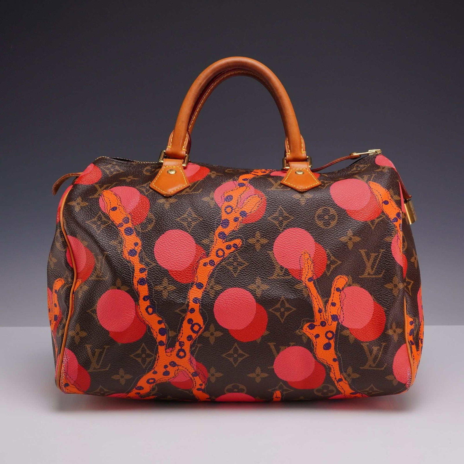 Louis Vuitton Limited Edition Monogram Canvas Grenade Ramages Speedy 30 Bag: This limited-edition Speedy 30 handbag is from the 2015 Louis Vuitton Ramages collection. The exterior is crafted from classic brown Monogram coated canvas featuring the Grenade Ramages print, a seaso