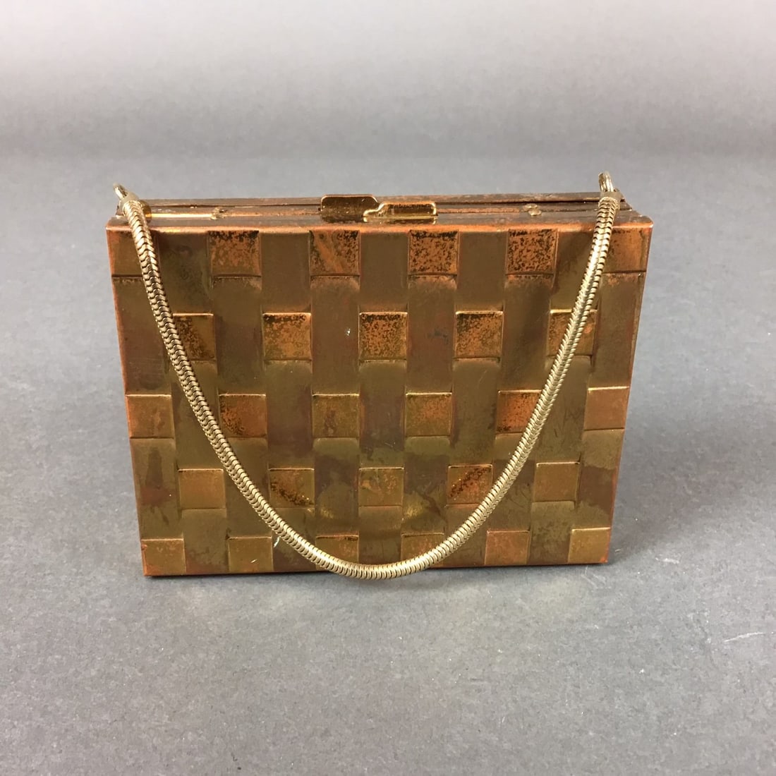 Vintage Gold Compact Case with Lipstick Mirror and Chain Purse Cigarette Case: This mid-20th century gold-toned metal vanity carryall is designed as a multi-functional compact purse. The rectangular exterior features a textured basketweave pattern and is equipped with a gold-ton