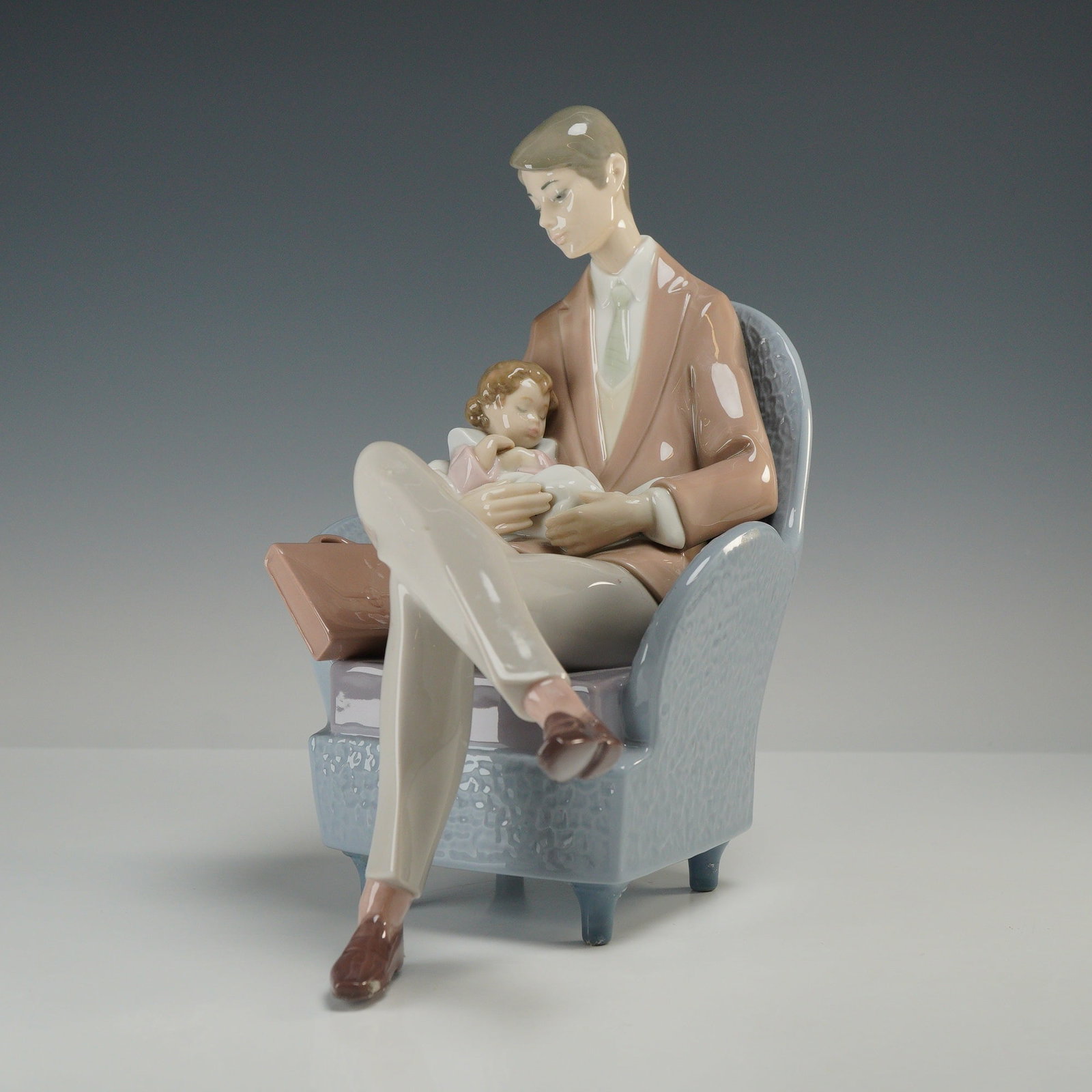Lladro Porcelain Figurine Daddy's Blessing 01006504 with Original Box: This glazed porcelain figurine, titled Daddy's Blessing, is a Lladro production handmade in Spain and designed by sculptor Francisco Polope. The sculpture depicts a father in professional attire, incl