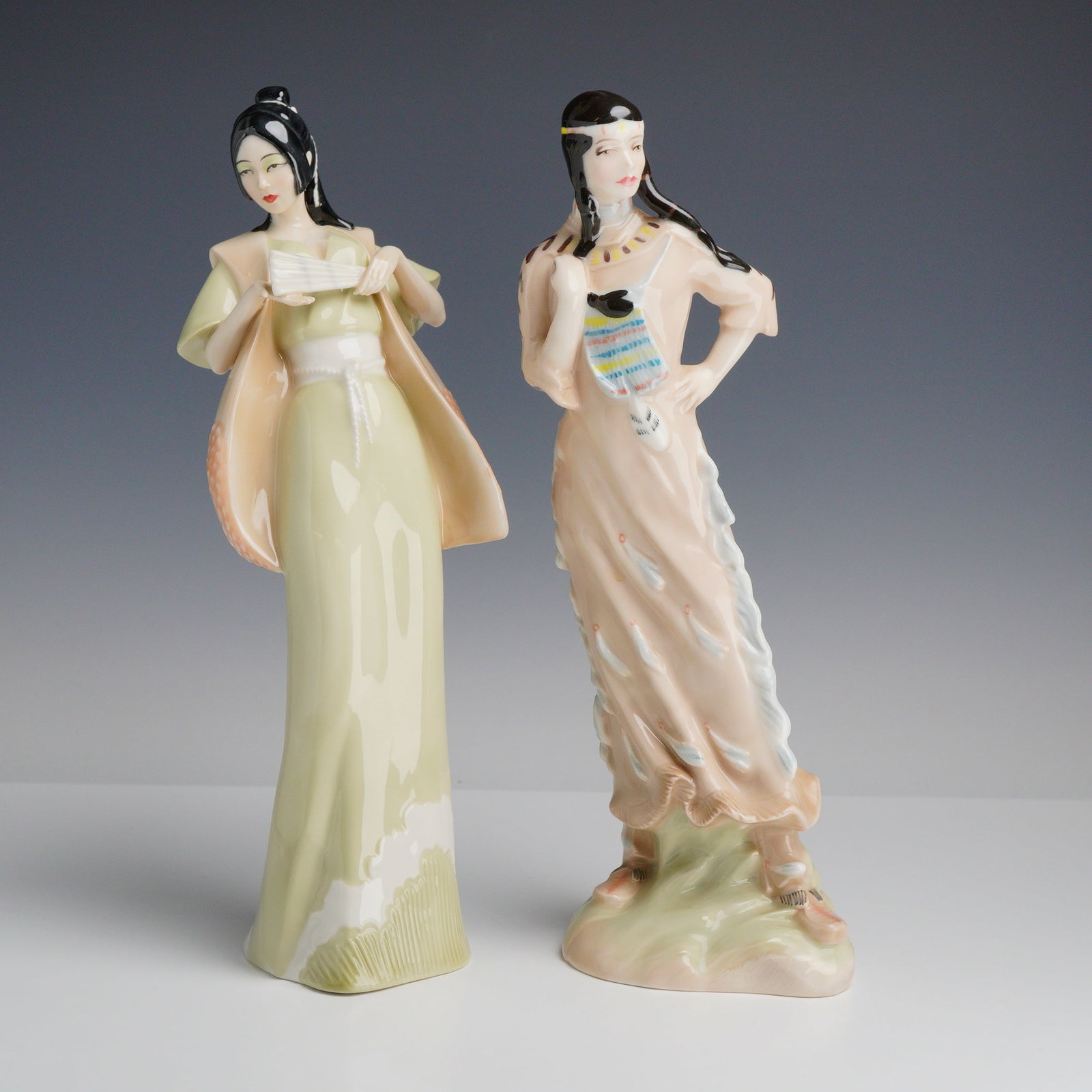 2pc Royal Doulton Reflections Figurines Cherry Blossom & Indian Maiden: This pair of glazed porcelain figurines is from the Royal Doulton Reflections series, produced in England. The first figurine, titled Cherry Blossom (HN 3092), was modeled by P. Parsons and copyrighte