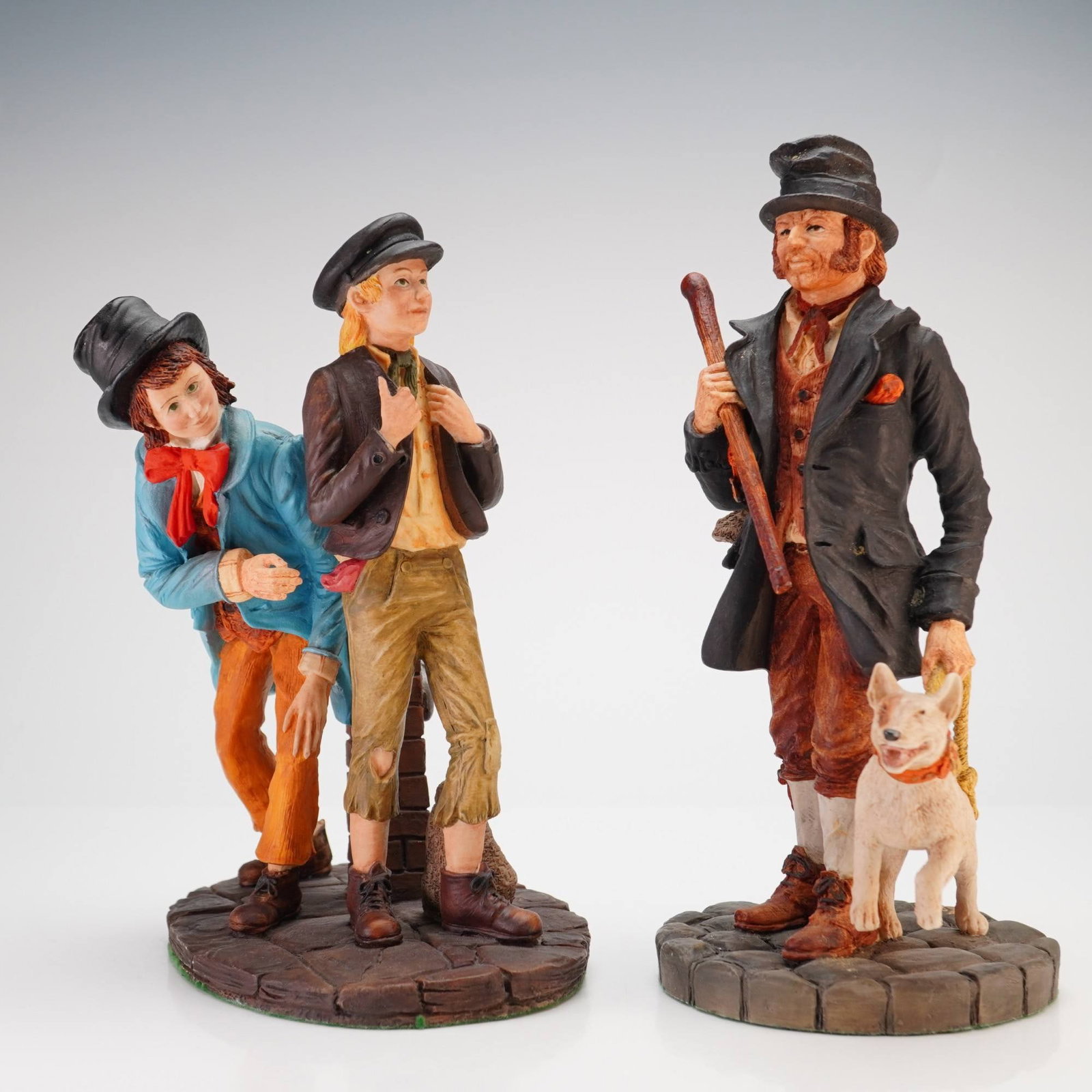 2pc Royal Doulton Hand-made Sculptures Bill Sykes & Oliver Twist and Artful Dodger: This lot includes two Royal Doulton hand-made resin sculptures from the Charles Dickens character series. The first figurine, titled Oliver Twist and Artful Dodger (HN3786), depicts the street childre