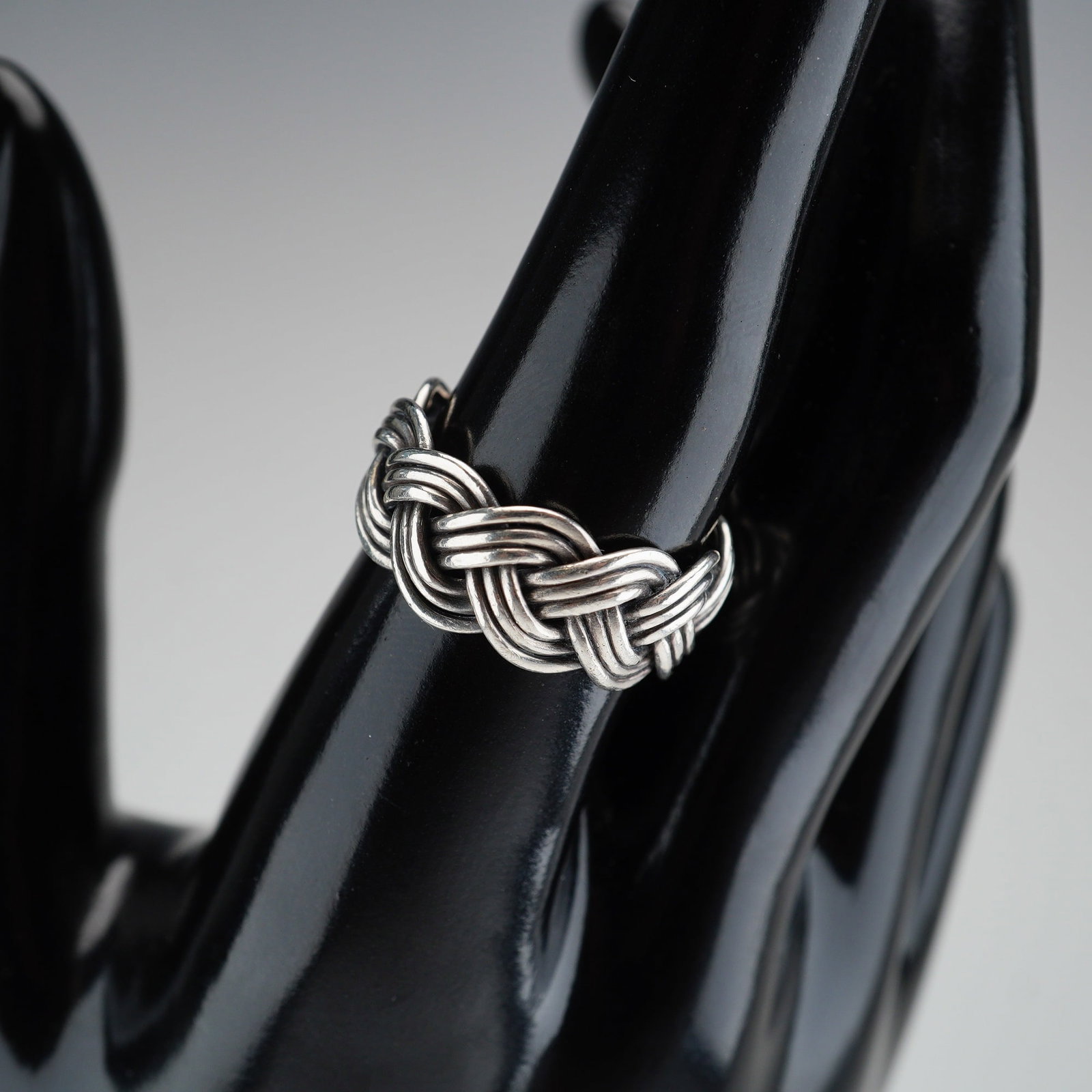 Mexican Sterling Silver Braided Band Ring: A sterling silver band ring with a braided design. Marked Mexico 925. Dimensions: Ring size: 8.25 Weight: 6 g