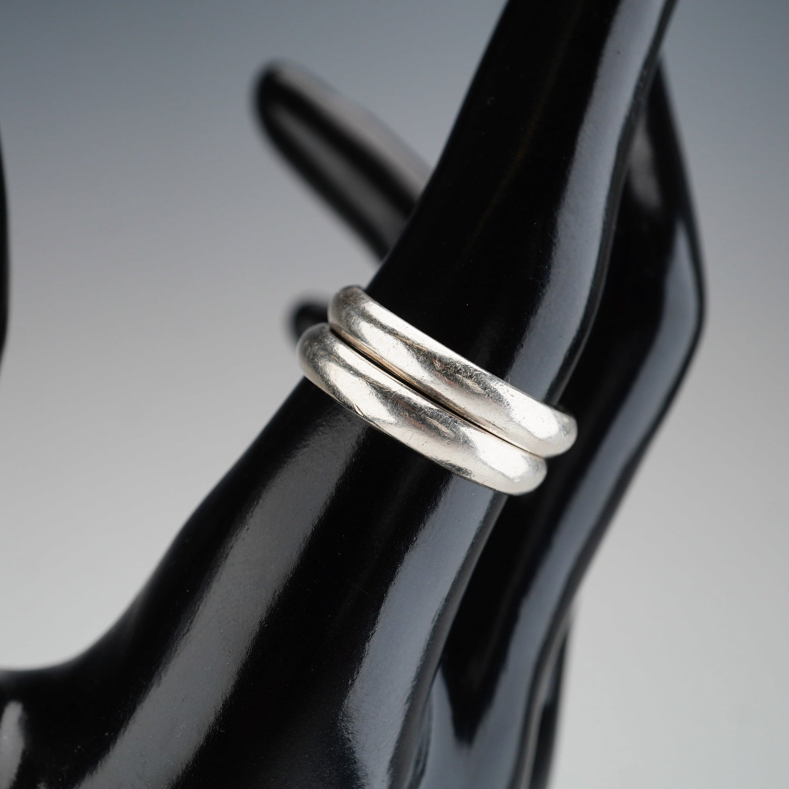 2pc Mexican Sterling Silver Wedding Bands: Two minimalist band rings crafted from sterling silver. Each band is marked TV-89 Mexico 925. Dimensions: Ring size: 8.75 Weight: Combined weight: 6.91 g