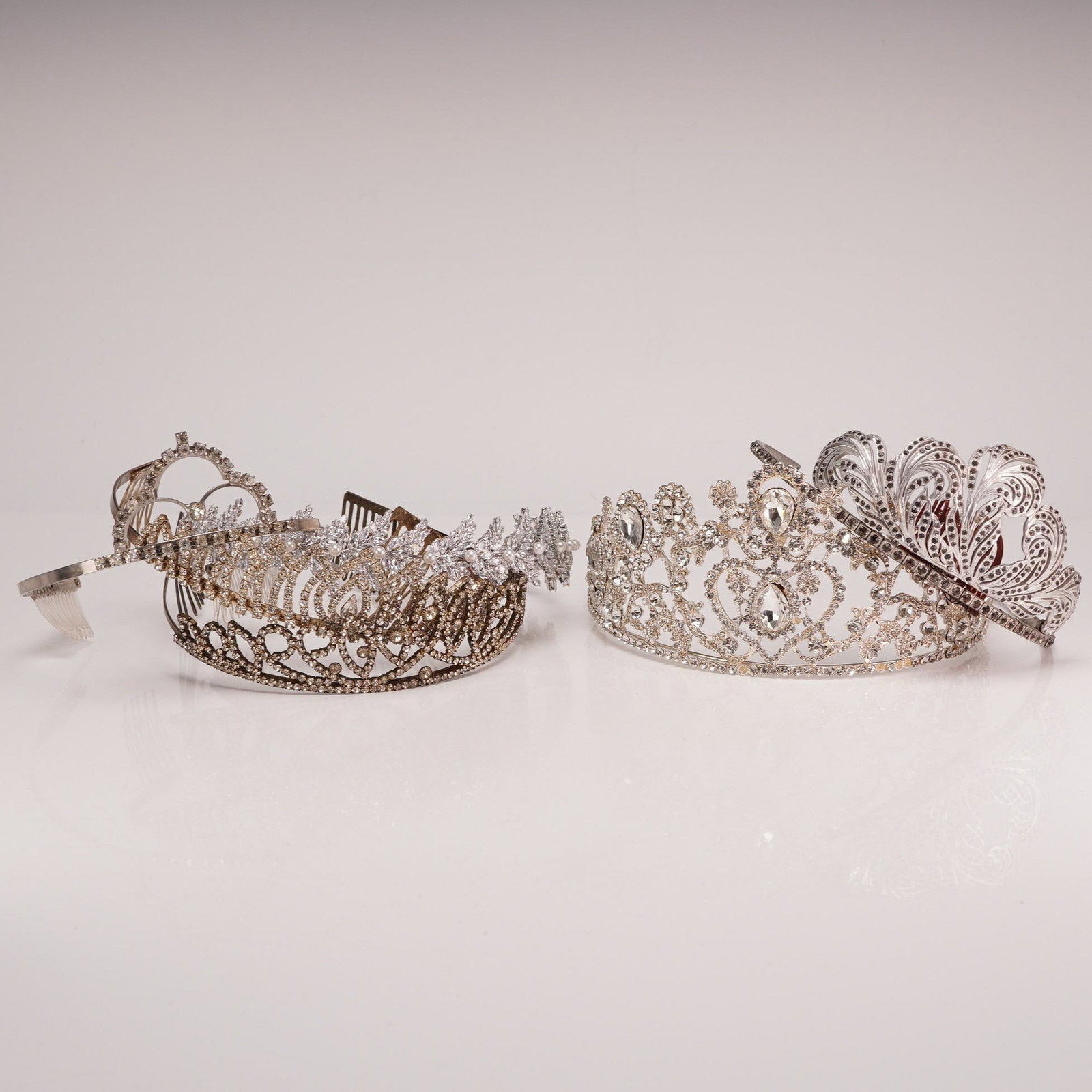6pc Jewel Encrusted Tiaras and Crowns w/ Rhinestones: This collection consists of six costume jewelry hair accessories constructed from silver-tone and gold-tone bases that are embellished with clear glass rhinestones in round, pear, and marquise cuts, a