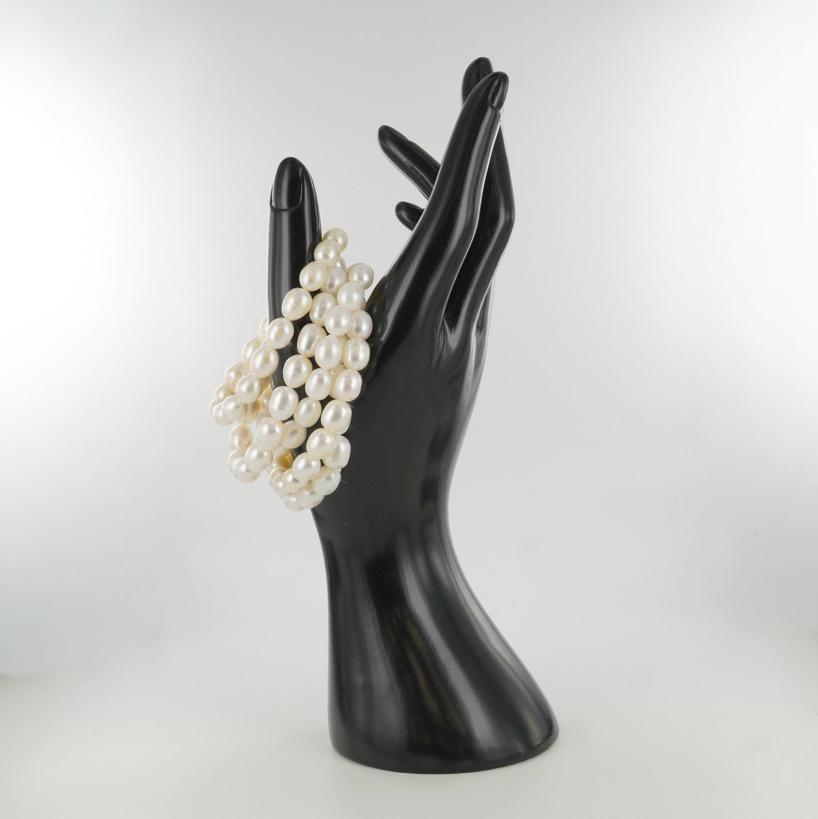 5pc Freshwater Pearl Expandable Bracelets: A lovely collection of five stretch bracelets featuring lustrous white freshwater pearls. Each bracelet is designed with smooth oval pearls that highlight their natural sheen and subtle variations, of