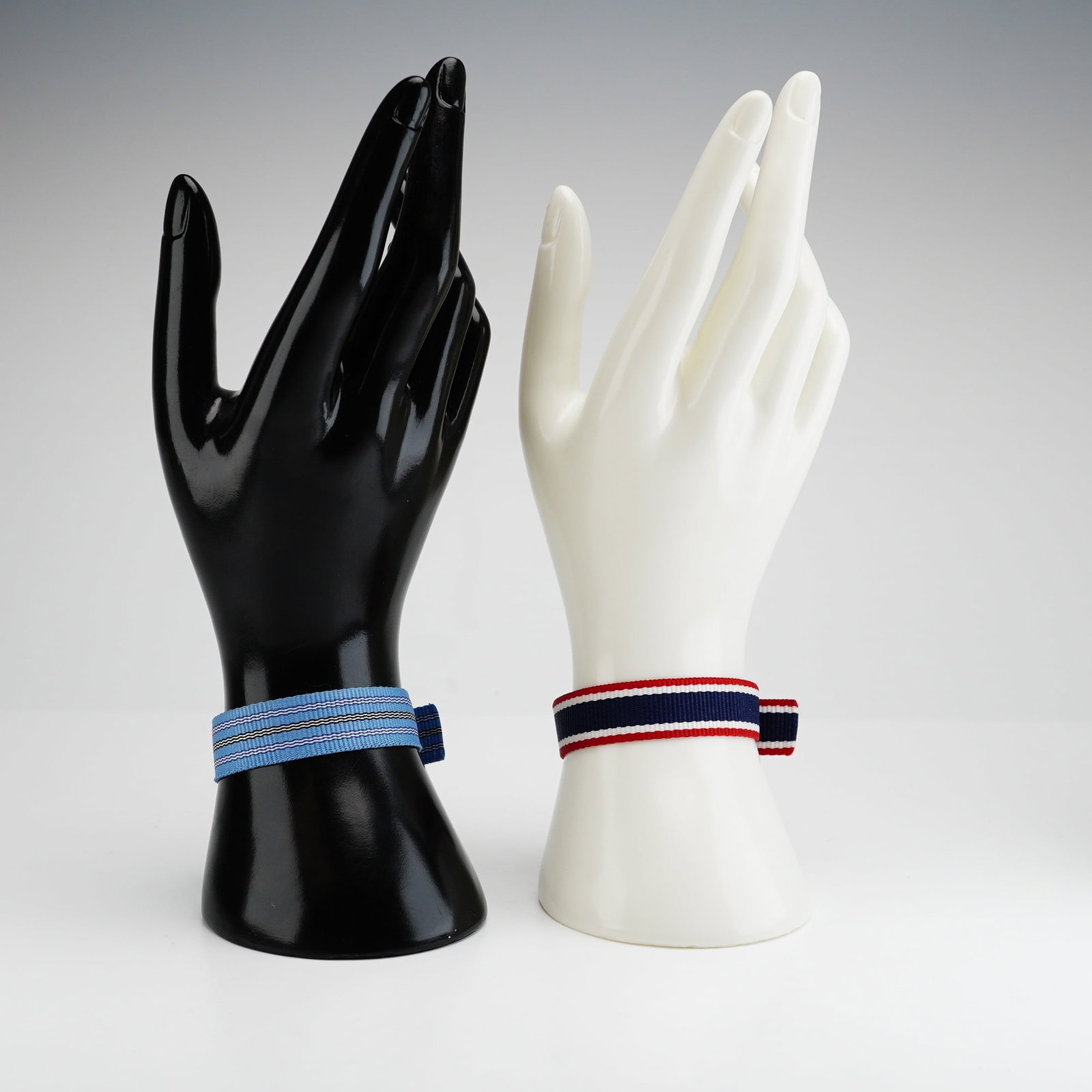 2pc Brooks Brothers Nylon Striped Watchbands: Two striped nylon watchbands from Brooks Brothers featuring buckle closures and stainless steel hardware. The styles include navy blue with red and white stripes, as well as light blue with white and 