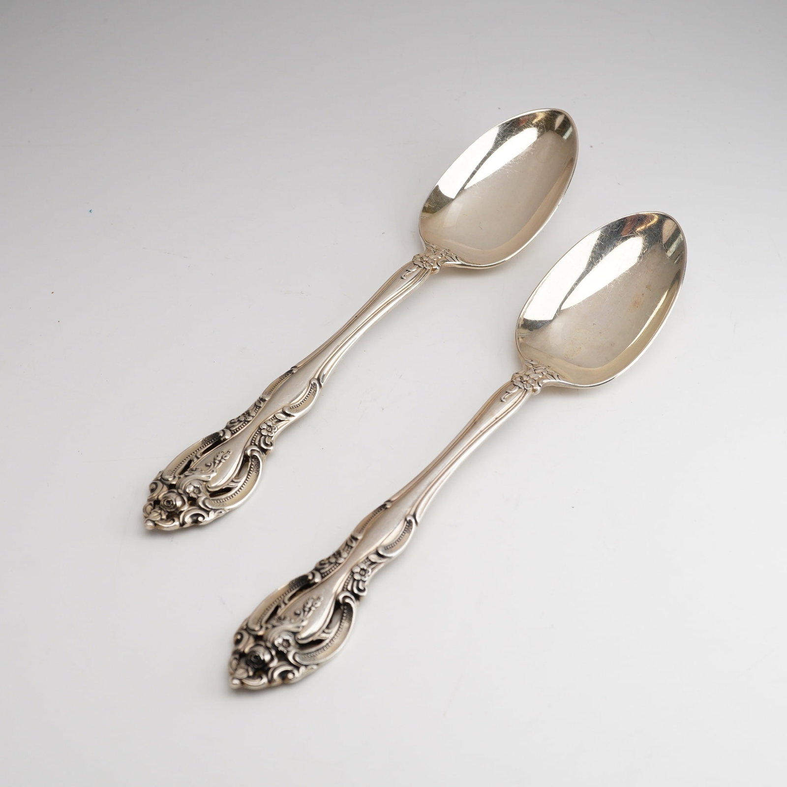2pc Gorham Sterling Silver Teaspoon, La Scala: First introduced in 1964, the pattern is designed in a highly ornate Rococo Revival style characterized by deep relief scrollwork, acanthus leaves, and rose blossoms. A defining feature of the design 