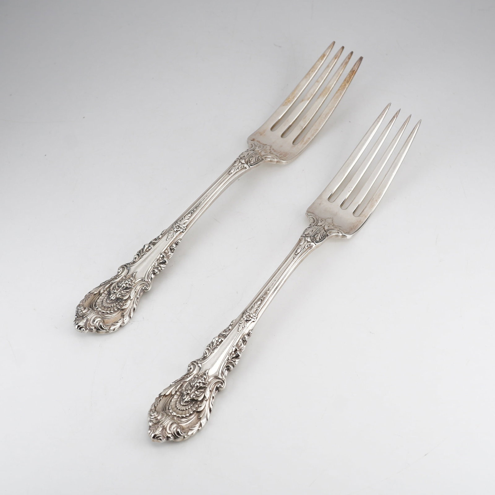 Pair of Wallace Sterling Silver Dinner Forks, Sir Christopher Pattern: This set consists of two sterling silver forks from Wallace Silversmiths in the Sir Christopher pattern, which was introduced in 1936 and designed by William S. Warren. The pattern is characterized by