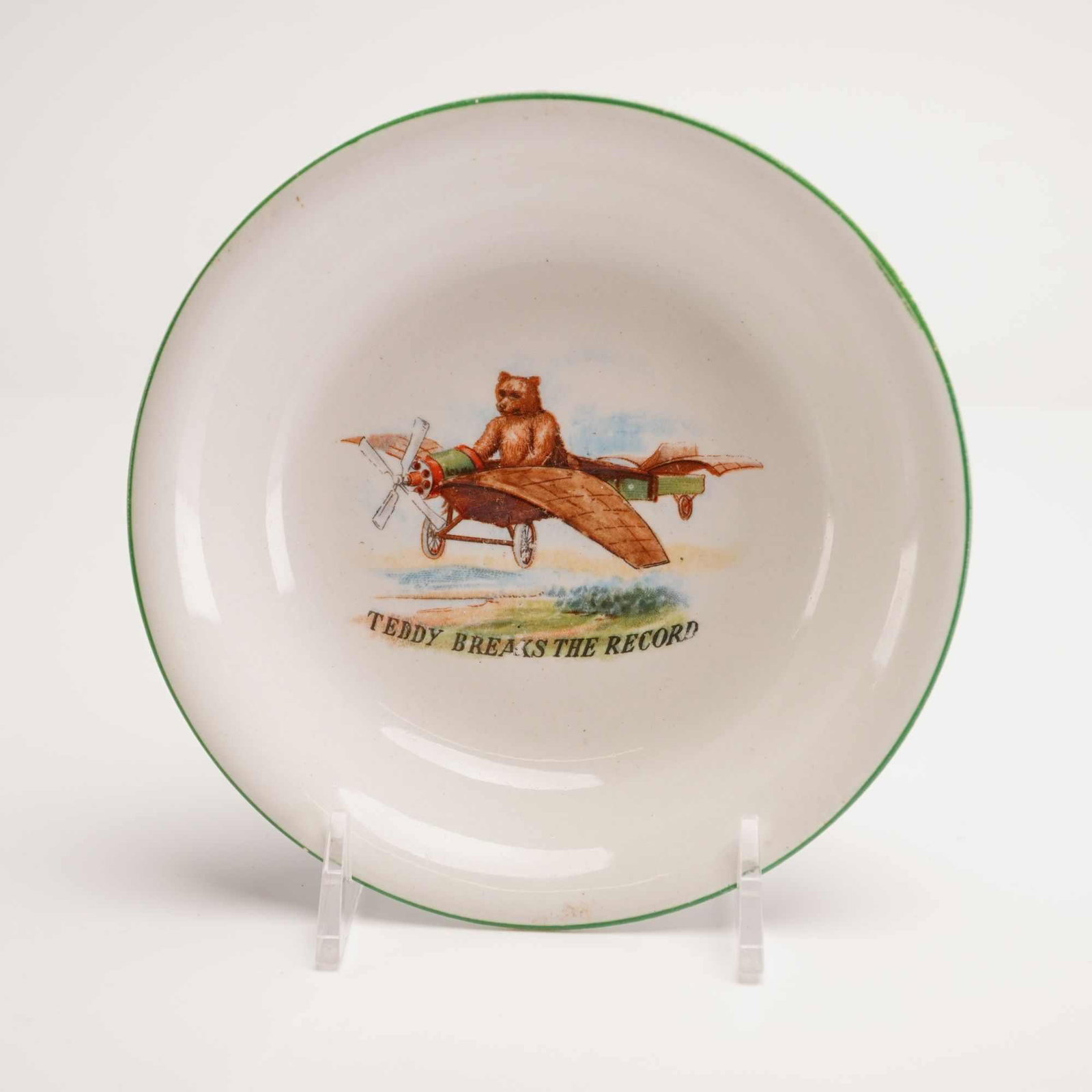 J&G Meakin Porcelain Nursery Bowl featuring Teddy Bear Breaks The Record: A small early 20th-century English porcelain nursery bowl manufactured by J. & G. Meakin as part of the SOL series. The interior features a multi-color transfer-printed illustration of a brown teddy b