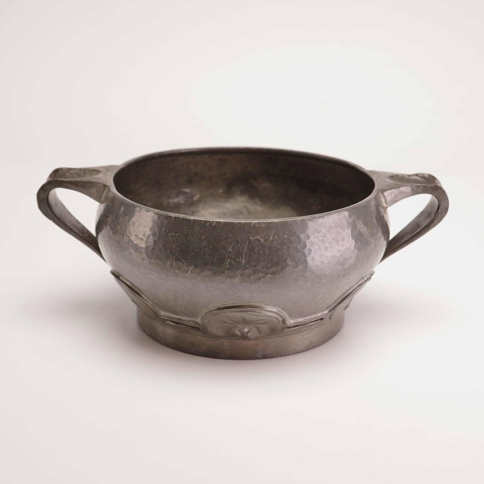 Liberty and Co. Tudric Pewter Two-Handled Bowl Pattern 01563: An Arts and Crafts period pewter bowl produced for Liberty and Co. under the Tudric line, pattern number 01563. The design is attributed to David Veasey and features a circular body with a planished f