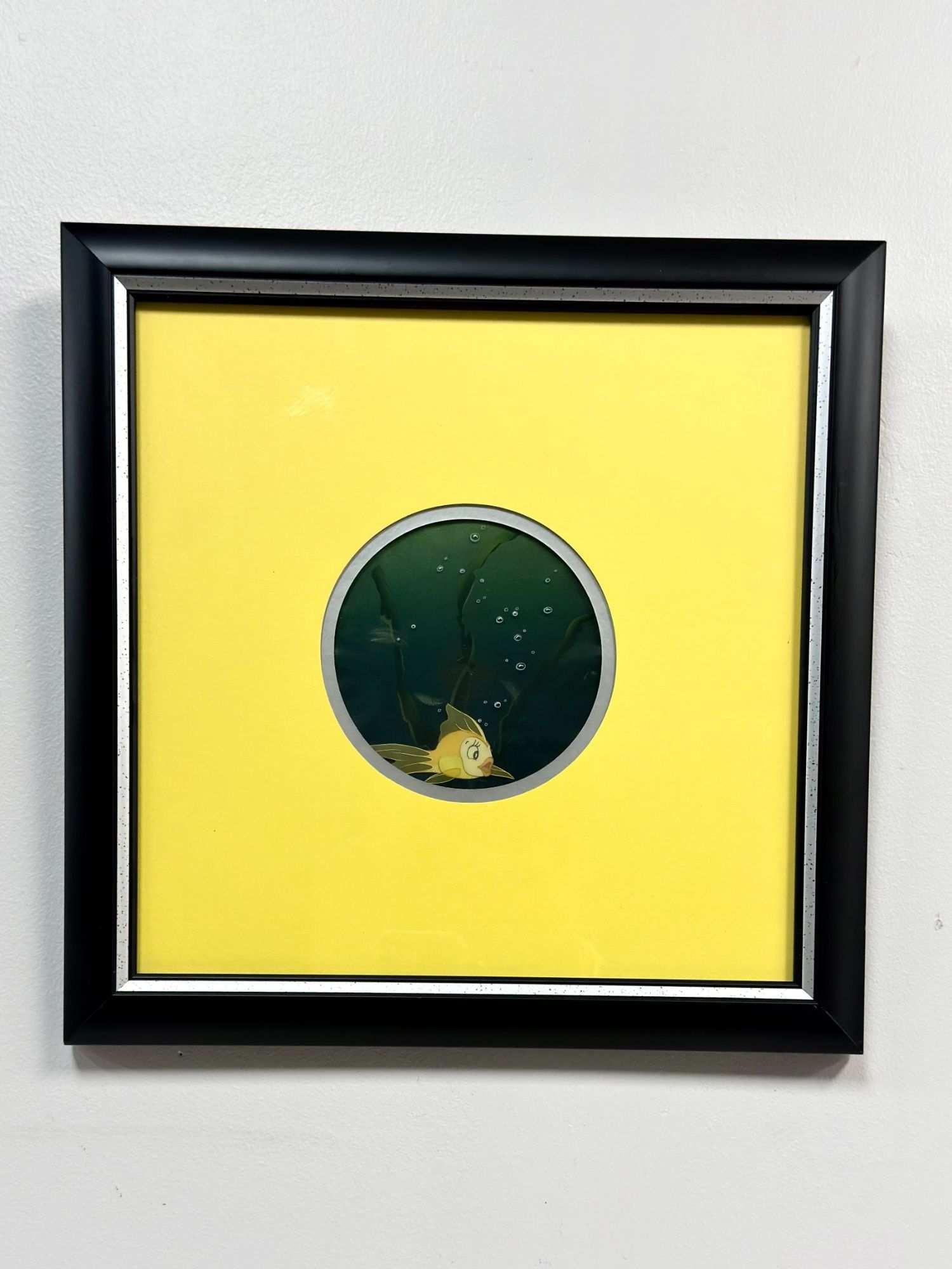 Original Disney Animation Production Sericel, Cleo from Pinocchio: This framed sericel depicts the character Cleo the goldfish from the Walt Disney animated feature film Pinocchio. Featuring the character swimming amidst stylized aquatic plants and rising bubbles aga