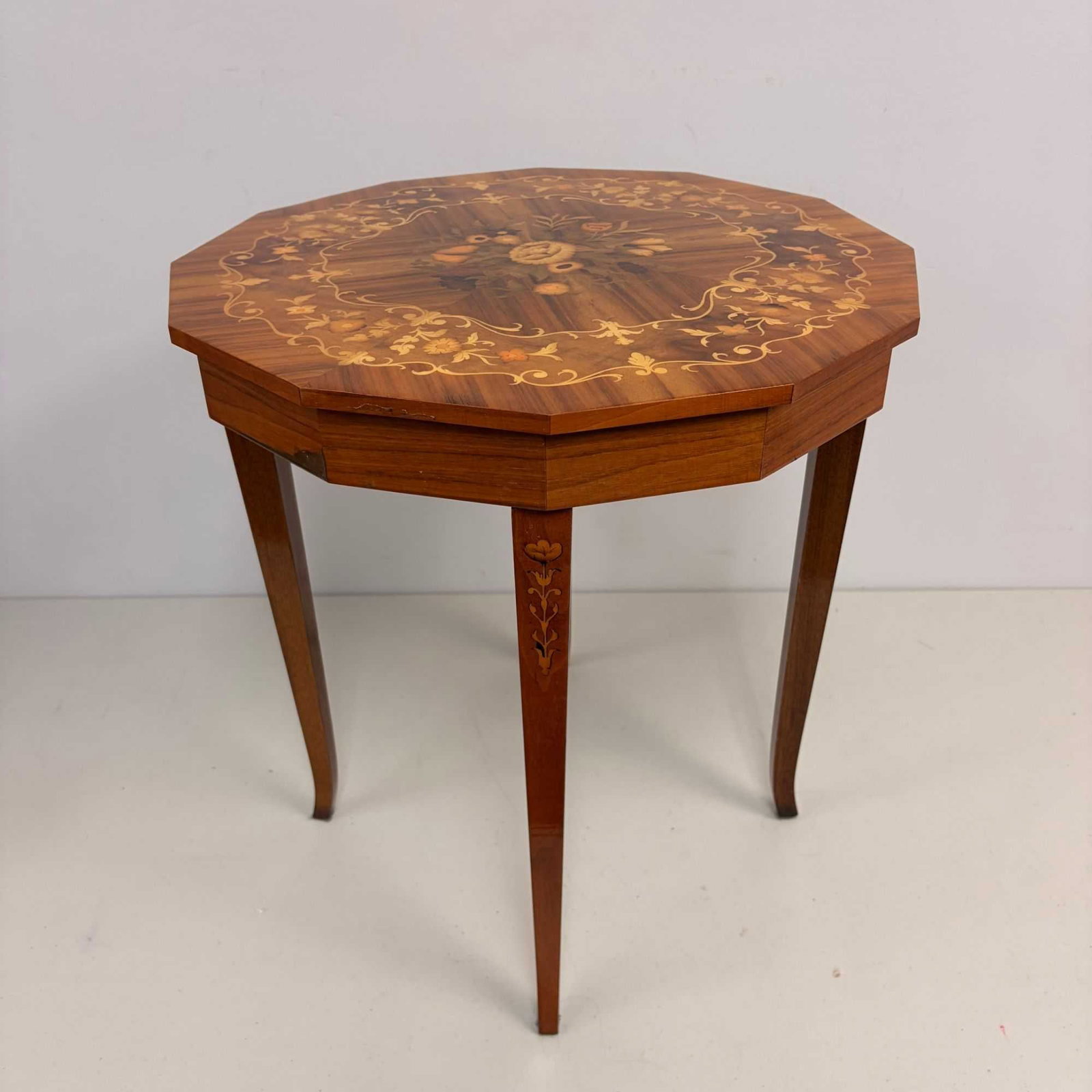 Italian Mid-Century Marquetry Inlaid Octagonal Musical Side Table: This Italian mid-century octagonal musical side table, also suited for use as a storage box, features elaborate marquetry and parquetry inlay. The construction is wood, likely walnut or fruitwood. The