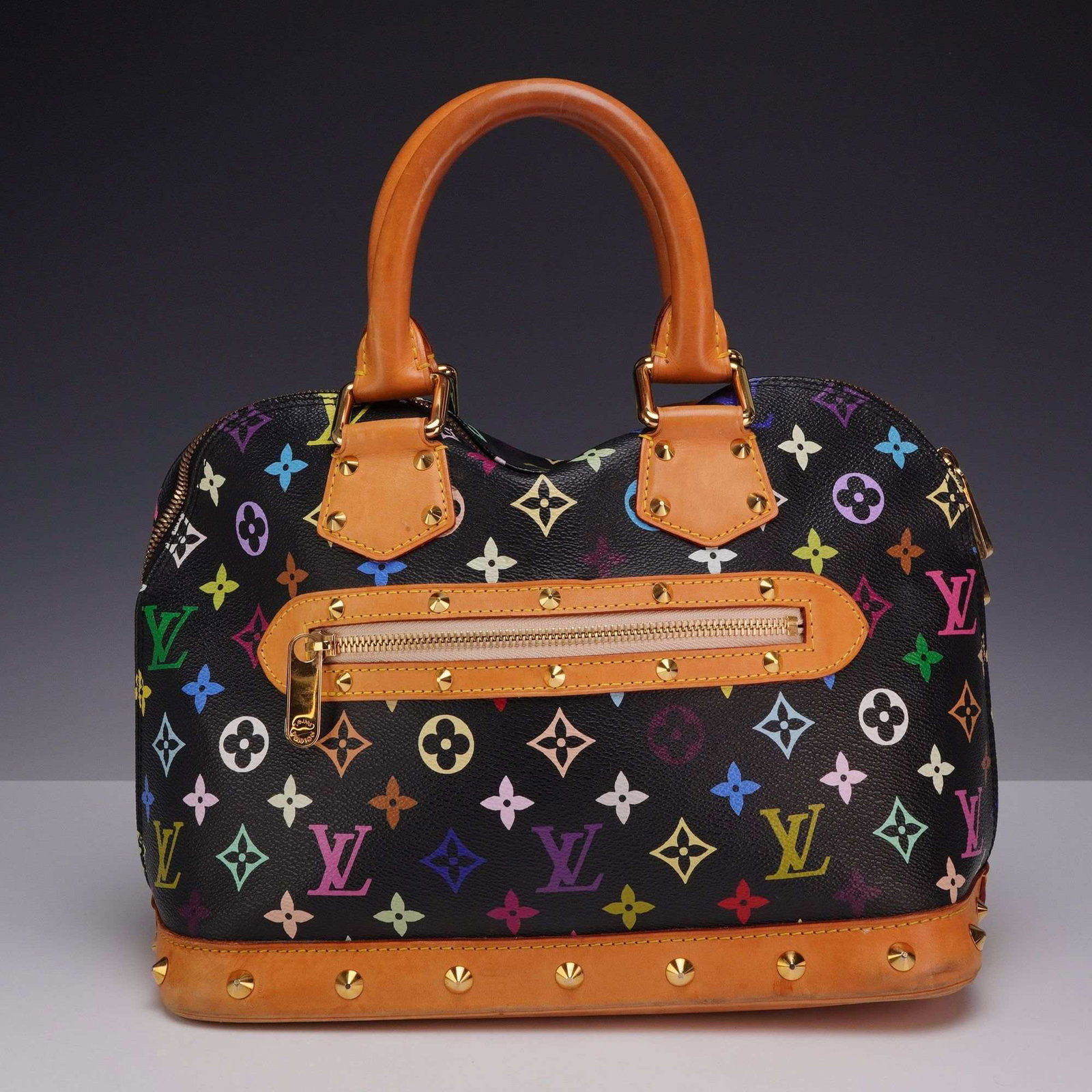 Louis Vuitton x Takashi Murakami Monogram Multicolore Alma PM Handbag: This Louis Vuitton Alma PM handbag is part of the limited edition Monogram Multicolore collection, a collaboration between the fashion house and artist Takashi Murakami. The exterior is crafted from b