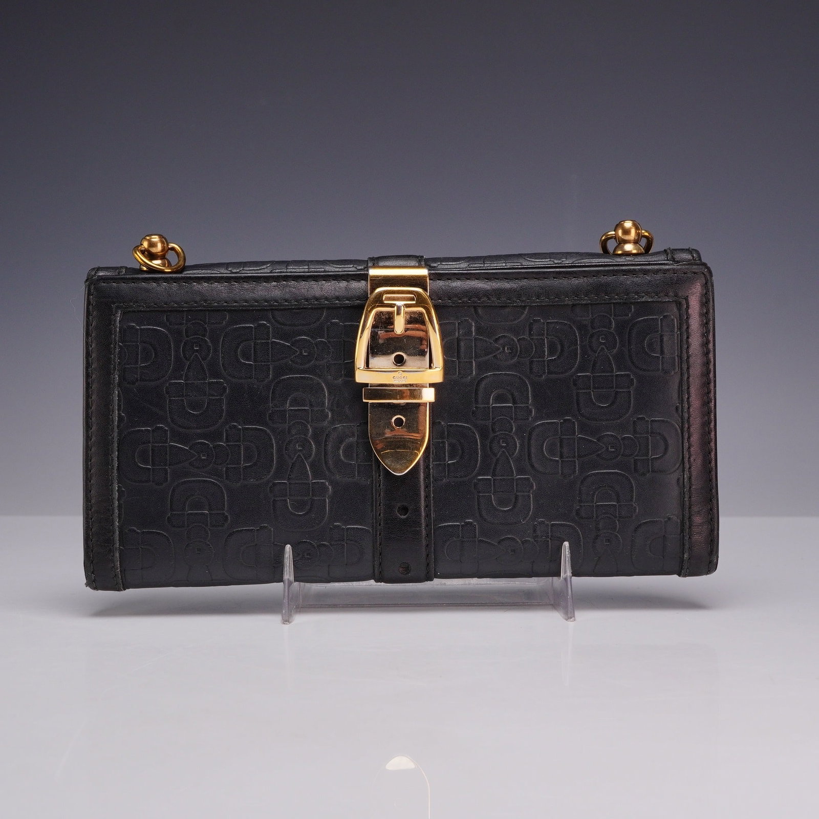 Gucci Horsebit Embossed Black Leather Continental Wallet with Original Box: This Gucci Horsebit Embossed Continental Wallet is constructed from black leather featuring an all-over embossed horsebit pattern. The design includes a prominent gold-tone horsebit buckle on a centra