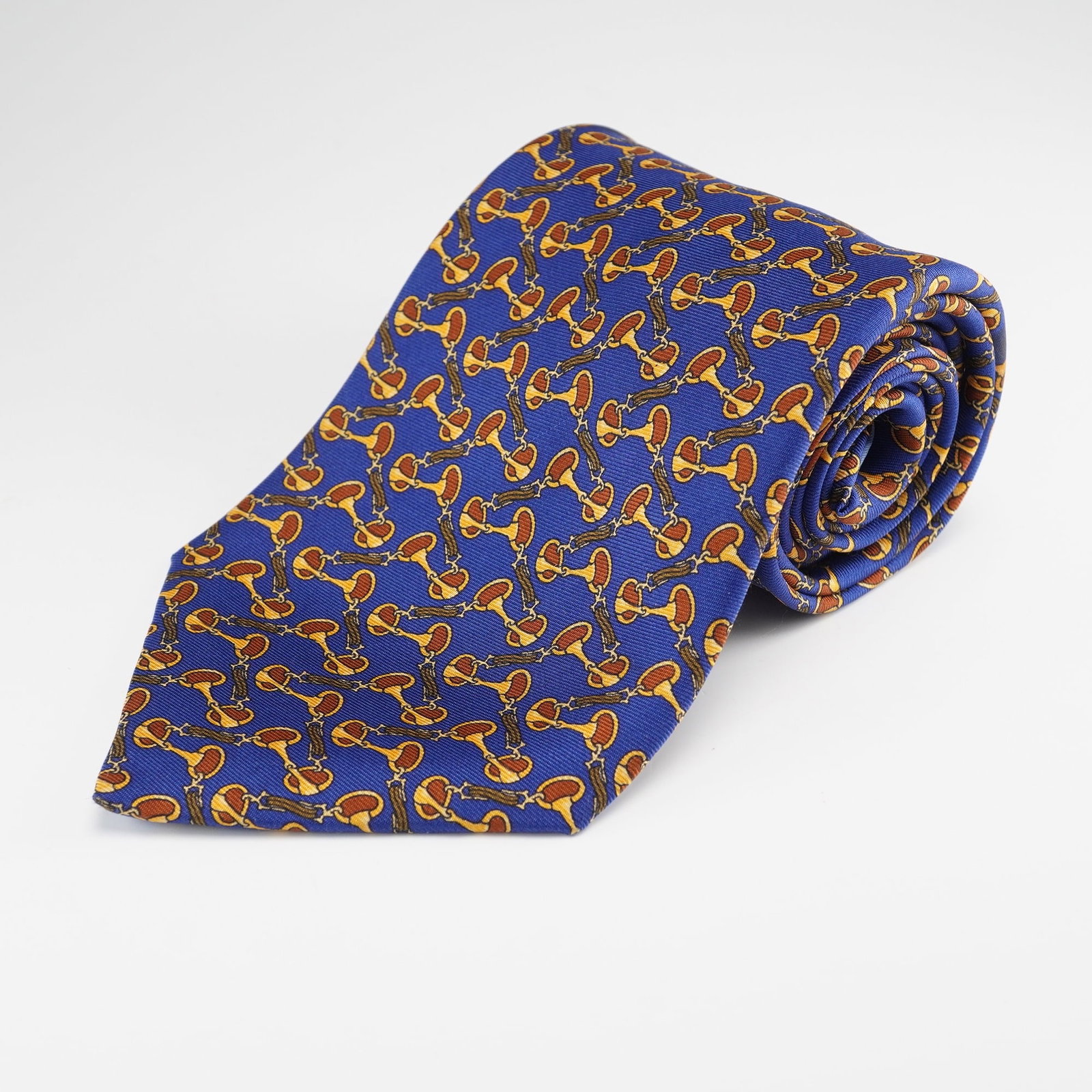 Richel Hand Made in Spain Silk Tie, Equestrian Pattern: A Richel Hand Made in Spain mens silk necktie. Crafted from what appears to be silk or a similar fine synthetic material, featuring a repeated equestrian-themed pattern of interconnected gold-toned ho