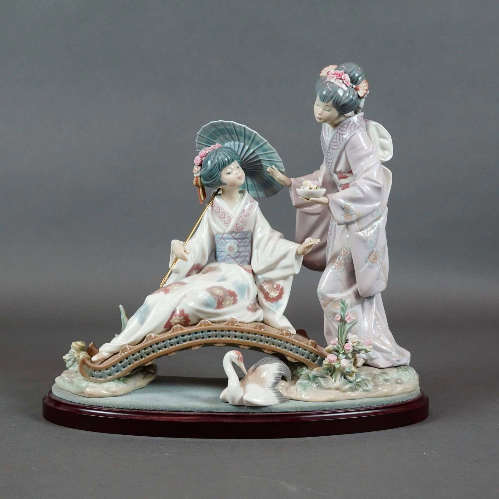 Lladro Springtime in Japan Porcelain Figurine 1001445 with Base: Lladro porcelain figurine titled Springtime in Japan, model number 1001445, sculpted by Salvador Debon. The group is constructed from molded and hand-assembled glazed porcelain. The scene depicts two 