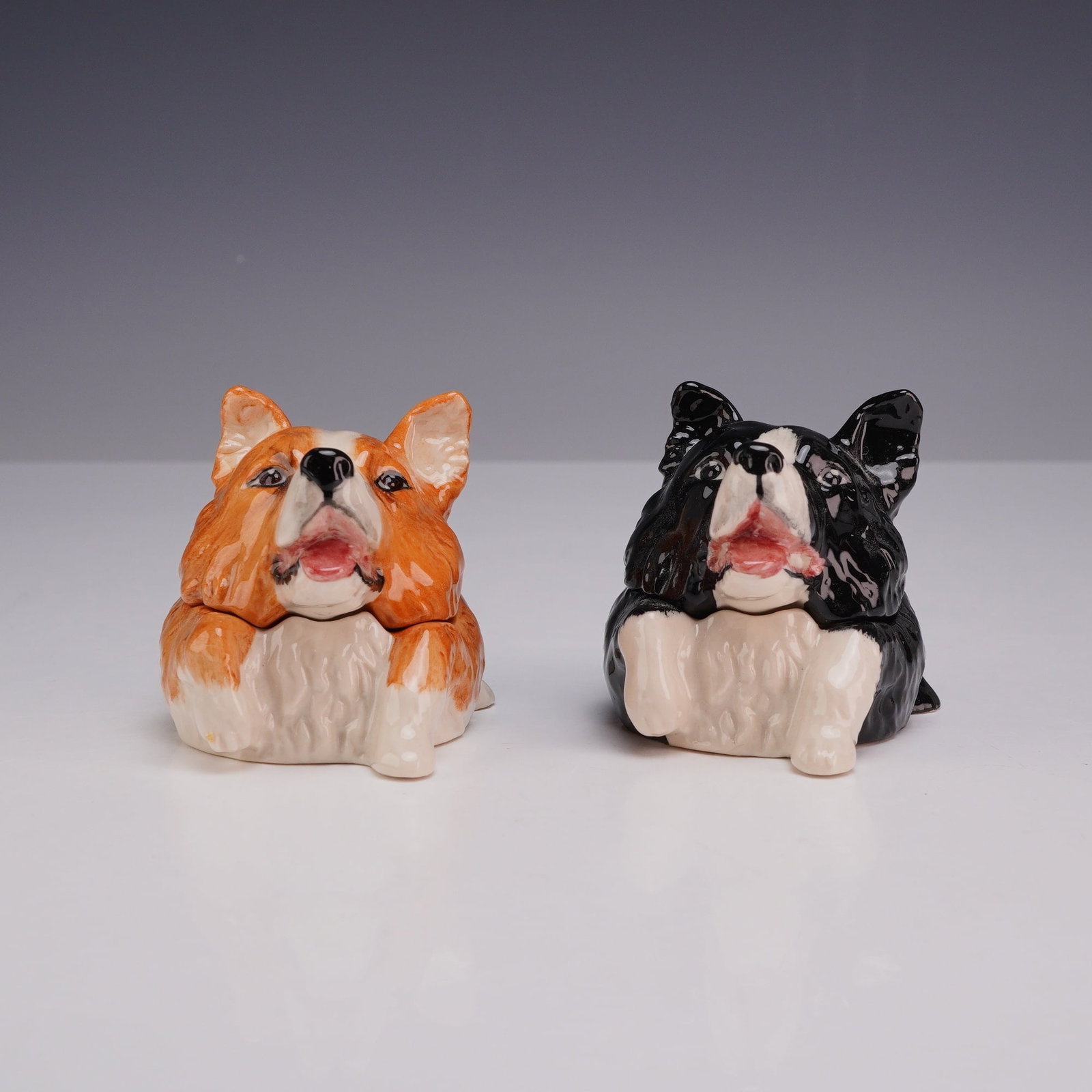Pair of Kevin Francis Face Pots Trinket Boxes, Rex The Collie: A pair of polychrome glazed ceramic miniature lidded trinket boxes from the Kevin Francis Face Pots collection, modeled as two Border Collies. Both figurines are identified by name on the interior as 