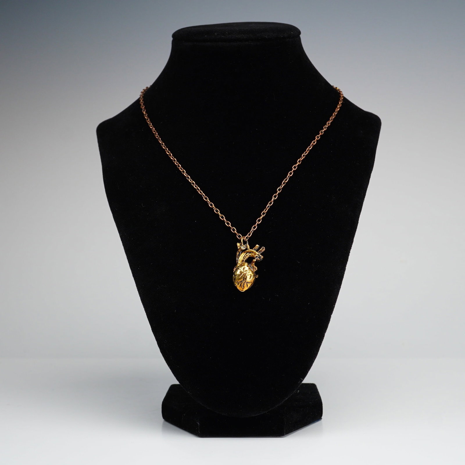 Anatomical Heart Gold-Tone Pendant Necklace: An anatomically detailed heart pendant and chain necklace in a gold-tone finish. Dimensions: 24"L Weight: 13.2 g